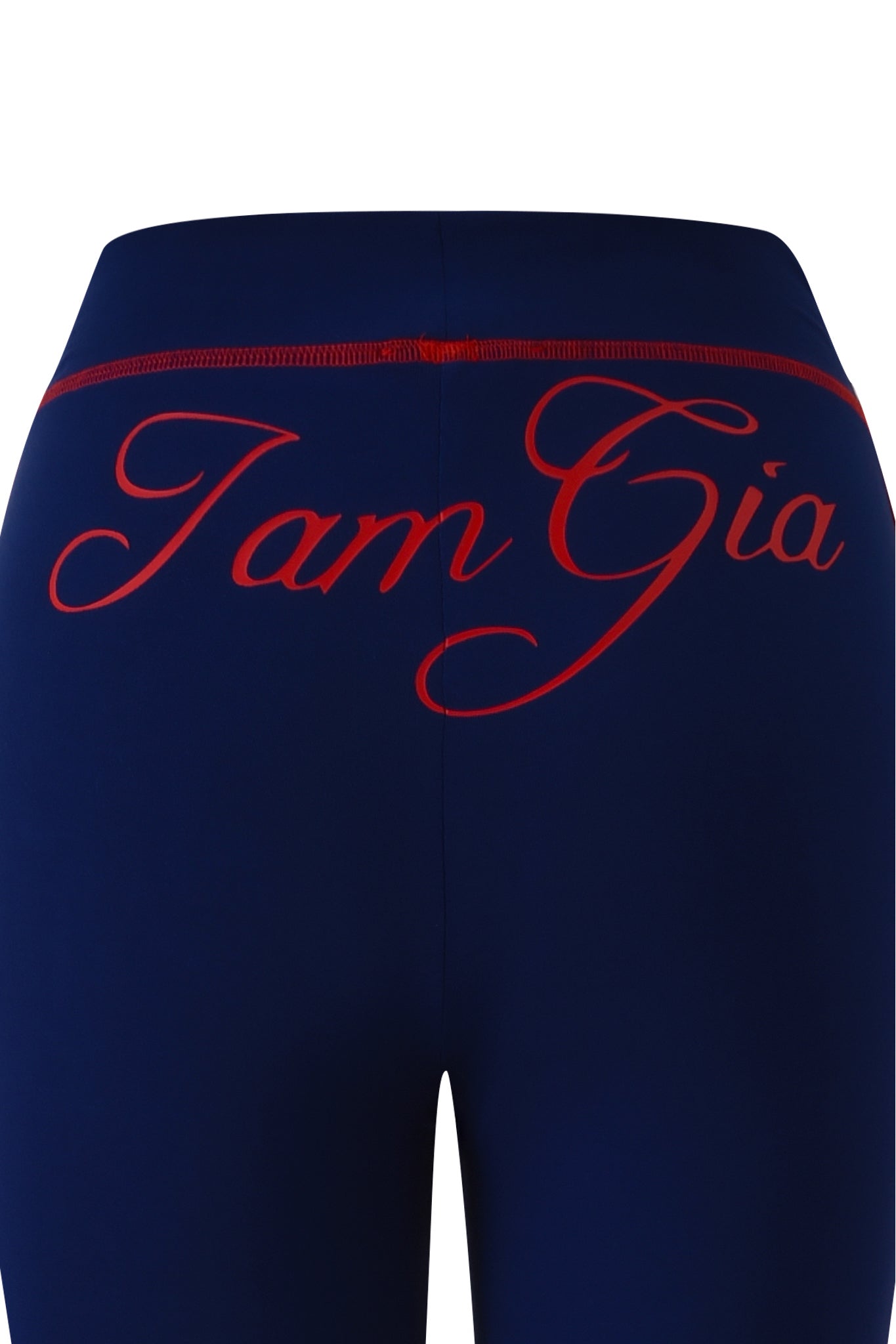 Close-up of the back of the BLARE SPORT TRACKPANT - NAVY by I.AM.GIA, crafted from buttery-soft fabric with bold red "I.AM.GIA" cursive lettering across the waistband and upper hips.
