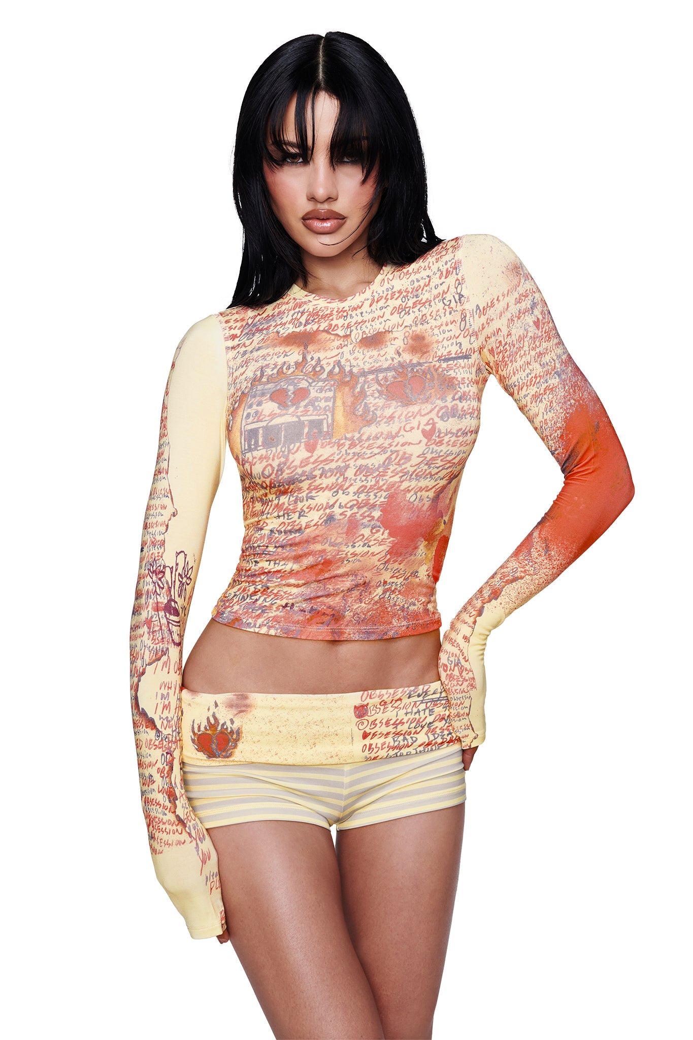 A woman poses in a fitted yellow long-sleeve "T-REX BLARE 2.0" tee by I.AM.GIA, standing against a plain white background.