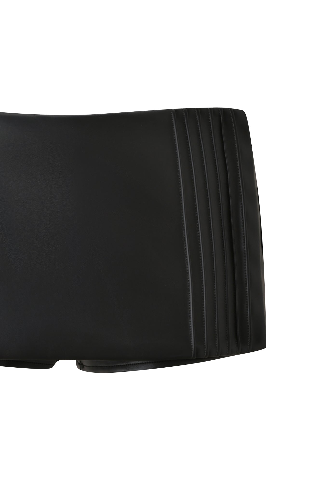 A close-up of the KESHA MICRO SKORT - BLACK by I.AM.GIA, highlighting pleated detailing on the right side that echoes the sharp structure of black formal pants, set against a white background.