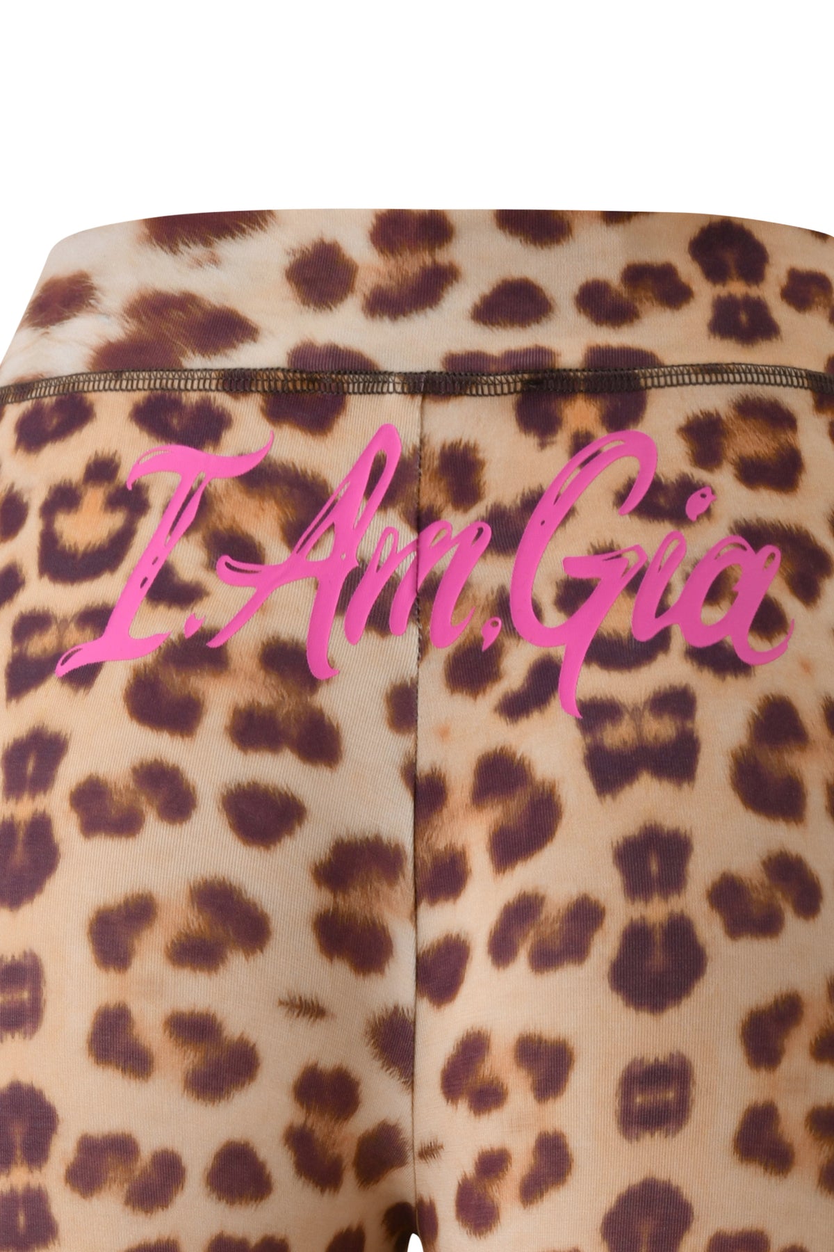 Close-up of wild card cheetah print fabric, reminiscent of the iconic I.AM.GIA T-REX BLARE CAPRI pants, featuring the words "I Am Gia" in bold pink script across the back.