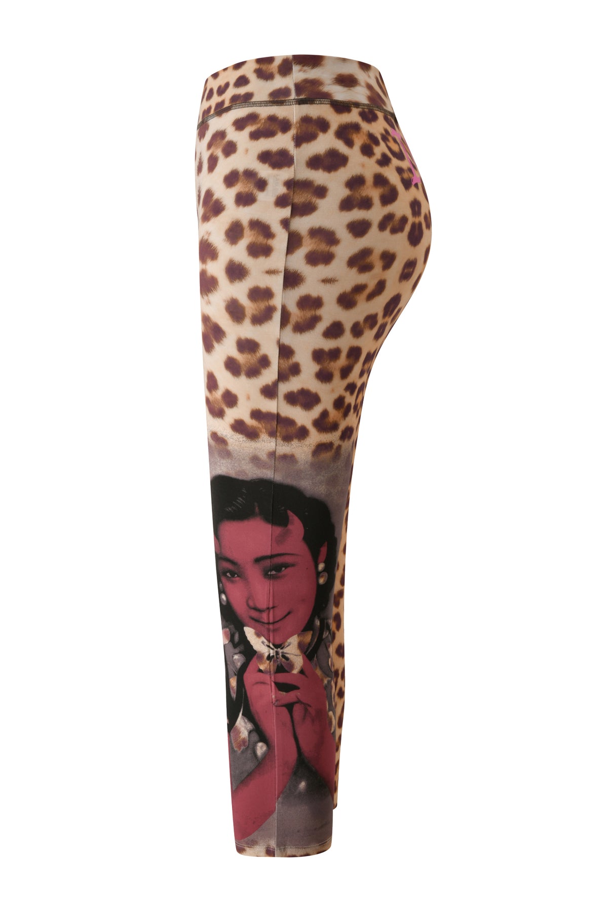 I.AM.GIA's T-REX BLARE CAPRI - WILD CARD features a bold leopard print reminiscent of trendy cheetah capri pants, with a vintage-style illustration of a woman holding a flower on the lower leg. The design is showcased from the side view as displayed on a mannequin.