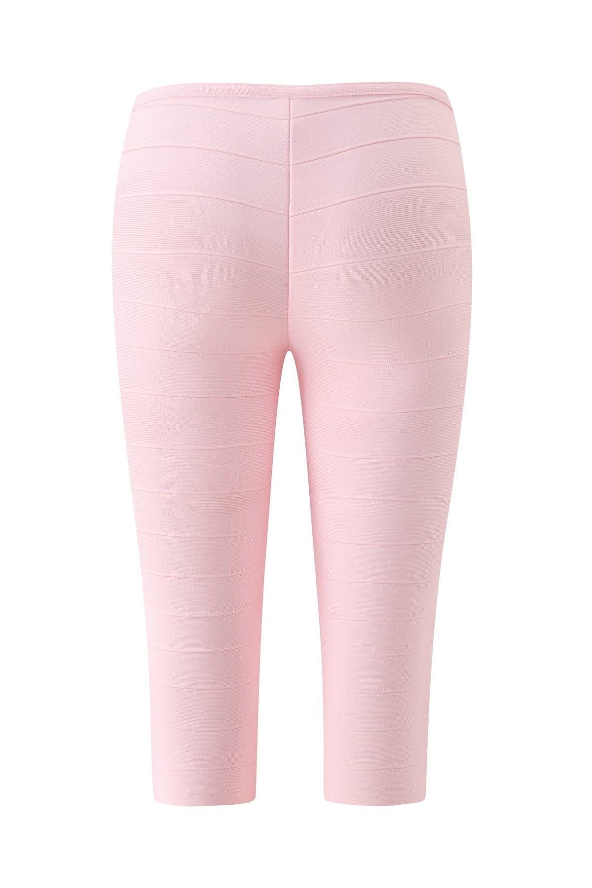 The MAEVE BANDAGE CAPRI - BABY PINK by I.AM.GIA is shown from the back against a white background. These light pink, knee-length capri pants feature horizontal seam detailing and a fitted, bodycon design.