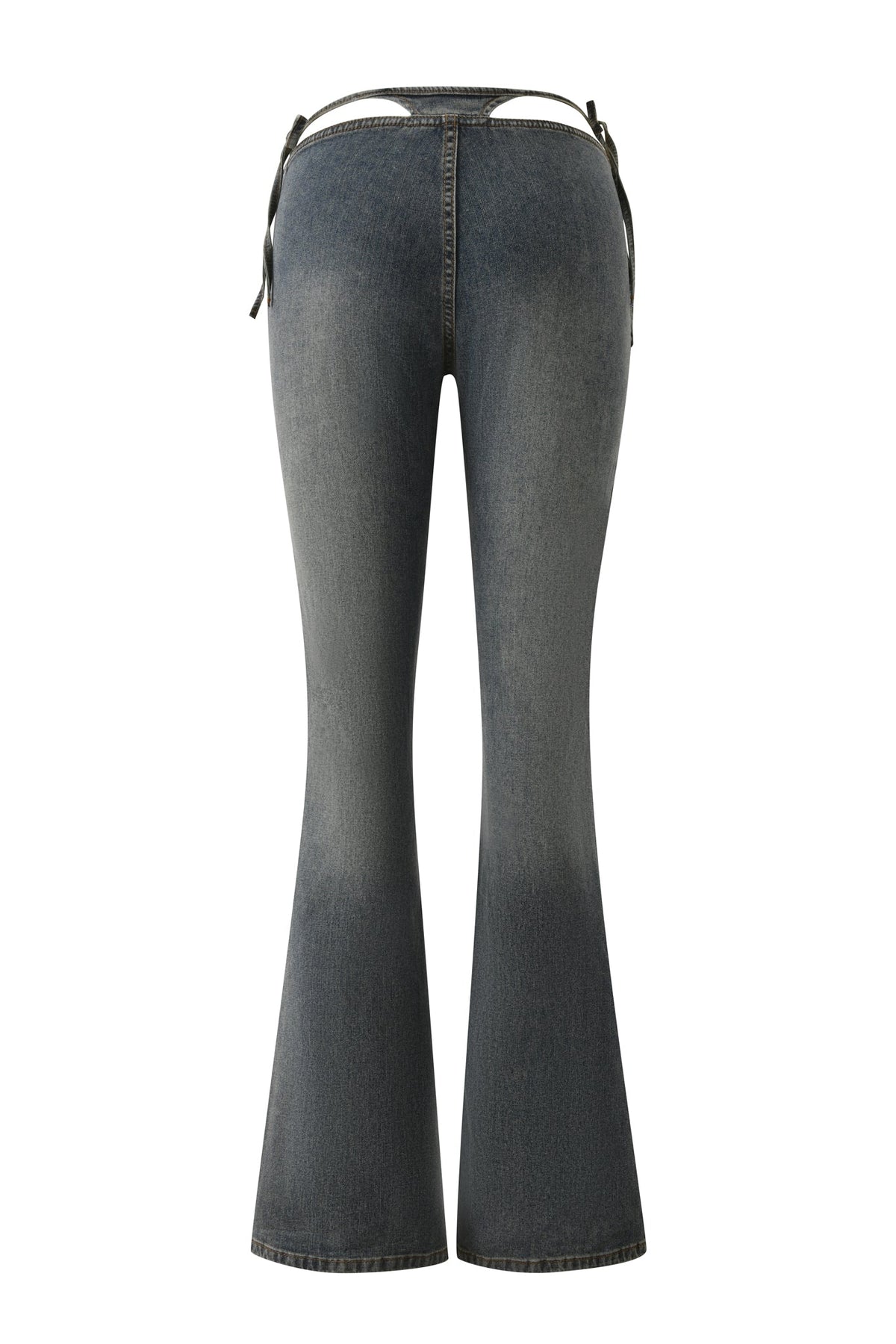 Back view of the JET G-STRING DENIM PANT in faded indigo by I.AM.GIA, featuring a high-waisted, flared silhouette with waist cut-outs, thin black tie straps, and a peek of G-string detail for an eye-catching Y2K-inspired look.
