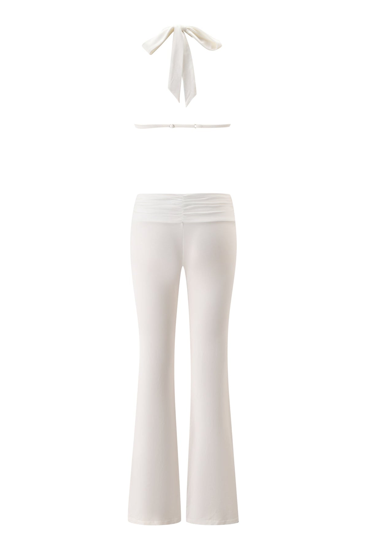 The CHER JUMPSUIT in white by I.AM.GIA is displayed from the back, showcasing its halter neckline with a tie at the neck and high-waisted, flared legs. Presented against a white background, this chic full-length jumpsuit offers a modern twist on classic style.