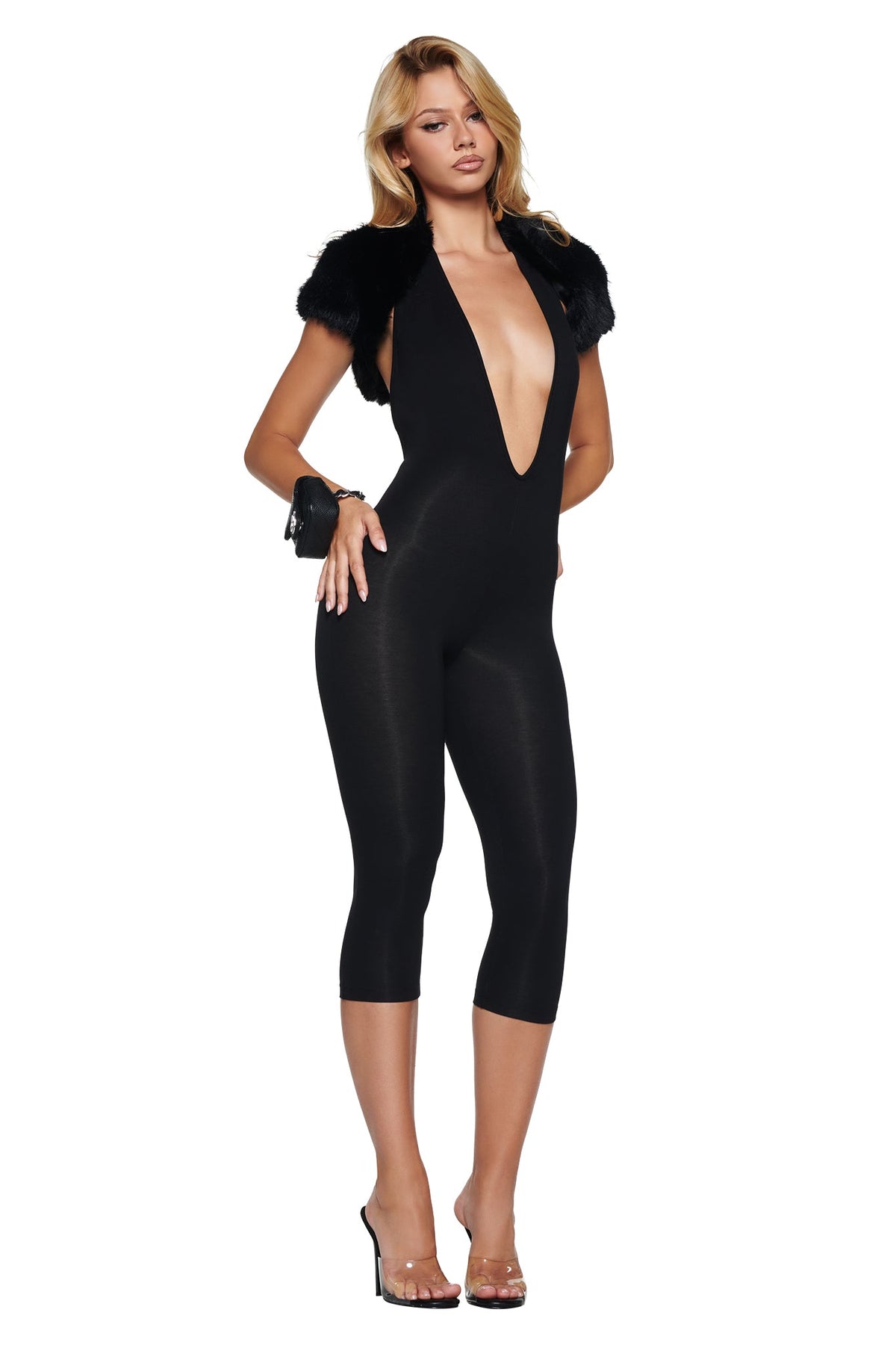 A person wears a black plunging-neckline bodysuit with an ALBA FAUX FUR CAP SLEEVE BOLERO - BLACK and cropped leggings.