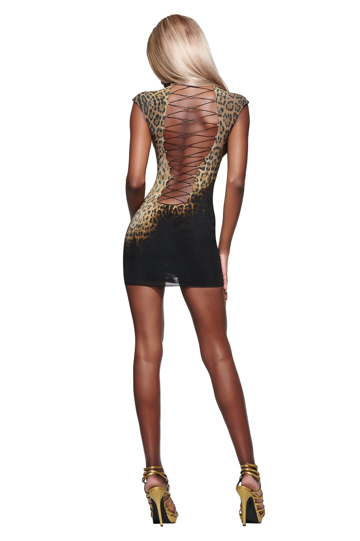 A woman with long blond hair models the I.AM.GIA ZOYA MINI DRESS in black leopard, showcasing its short, form-fitting silhouette and lace-up open back design as she stands with her back to the camera against a white background, paired with high heels.