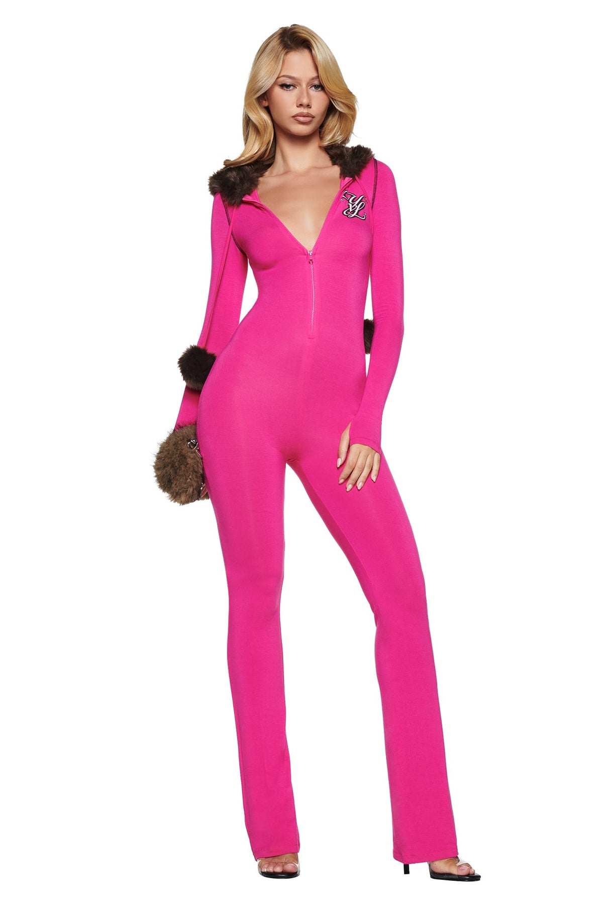A bright pink I.AM.GIA YVL BLARE FUR LINED JUMPSUIT with a zipper neckline, brown fur trim on the hood and sleeves, and a logo patch on the chest.