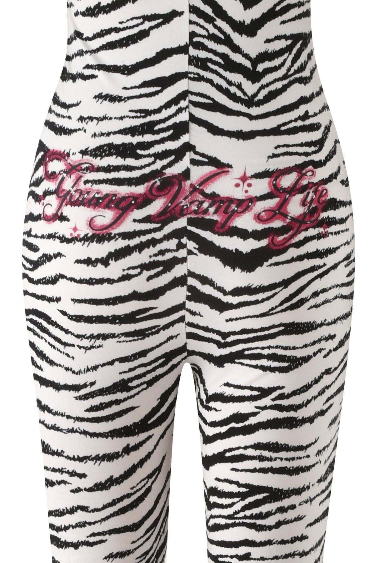 I.AM.GIA YVL BLARE FUR LINED JUMPSUIT - ZEBRA with a faux fur hood and “Young Vamp Life” in pink glitter on the back.