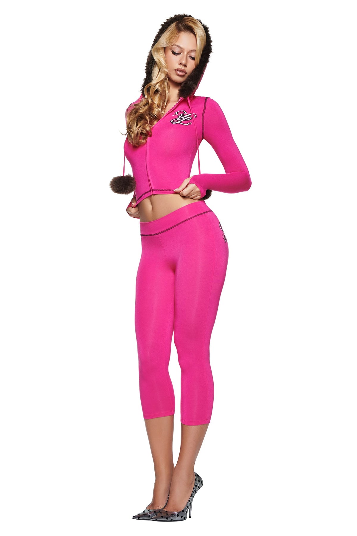 A person wearing a bright pink YVL BLARE FUR LINED HOODIE with a fur-trimmed hood and matching cropped leggings.