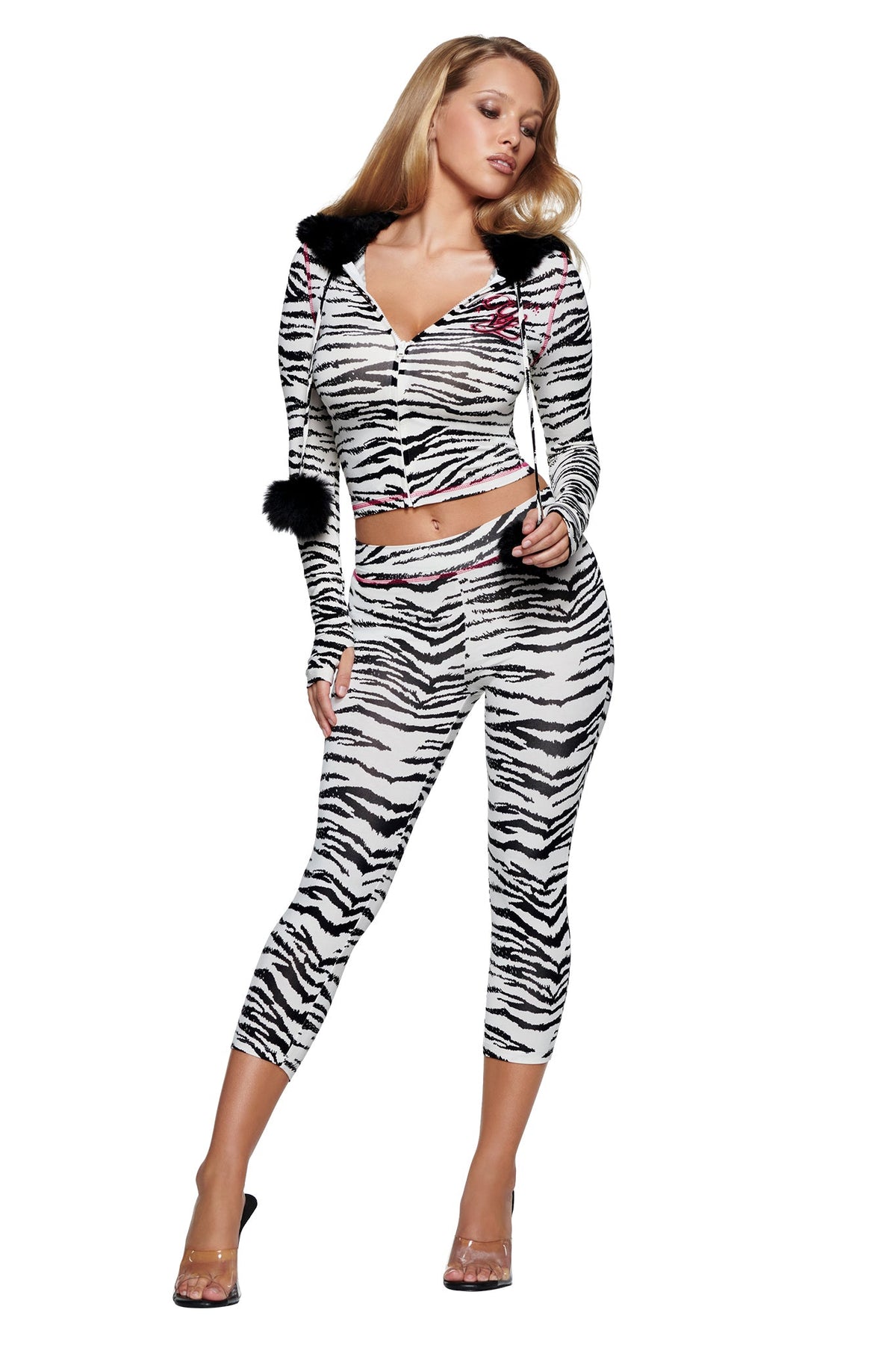 A person wears a cropped, long-sleeved I.AM.GIA YVL BLARE FUR LINED HOODIE - ZEBRA, featuring a black faux-fur trimmed hood and matching cropped leggings.