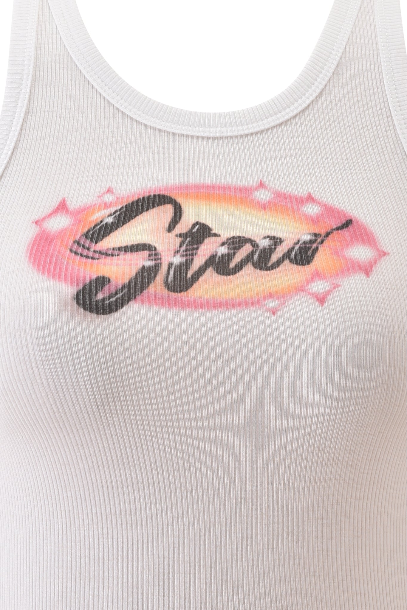 The PENELOPE TANK - STAR AIRBRUSH by I.AM.GIA is a white ribbed racer tank with "Star" in black script, a pink and yellow oval, and pink star accents. This bodycon fit adds playful style to any casual look.