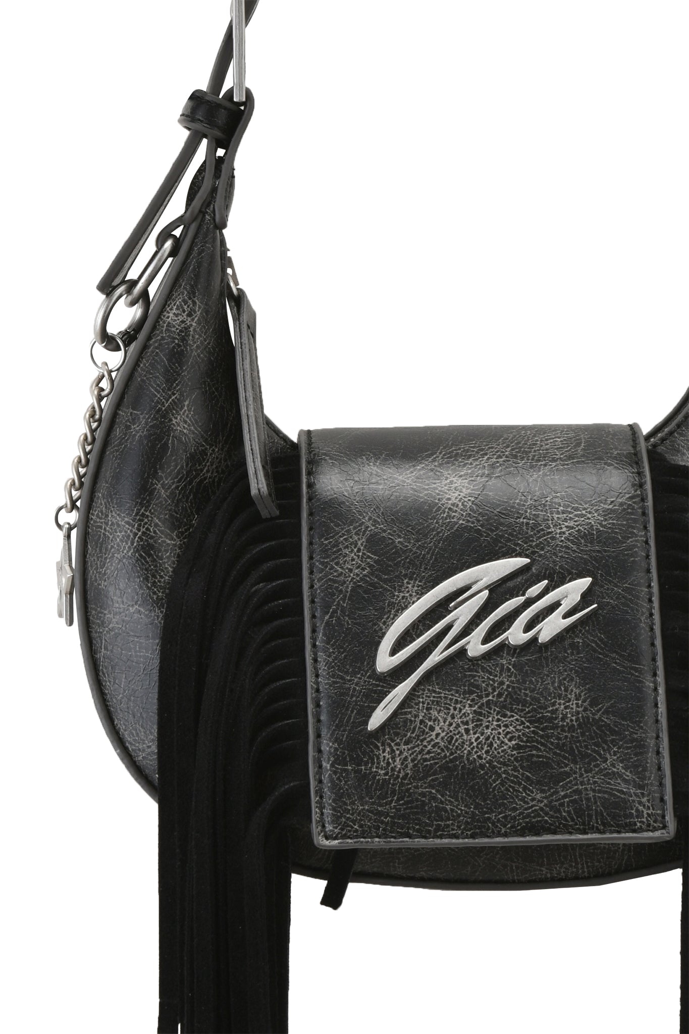 Close-up of the TIA BAG - BLACK FRINGE by I.AM.GIA, a black faux leather purse with a textured finish, fringe detail, silver "Gia" logo on the front flap, and a shoulder strap with chain accent.