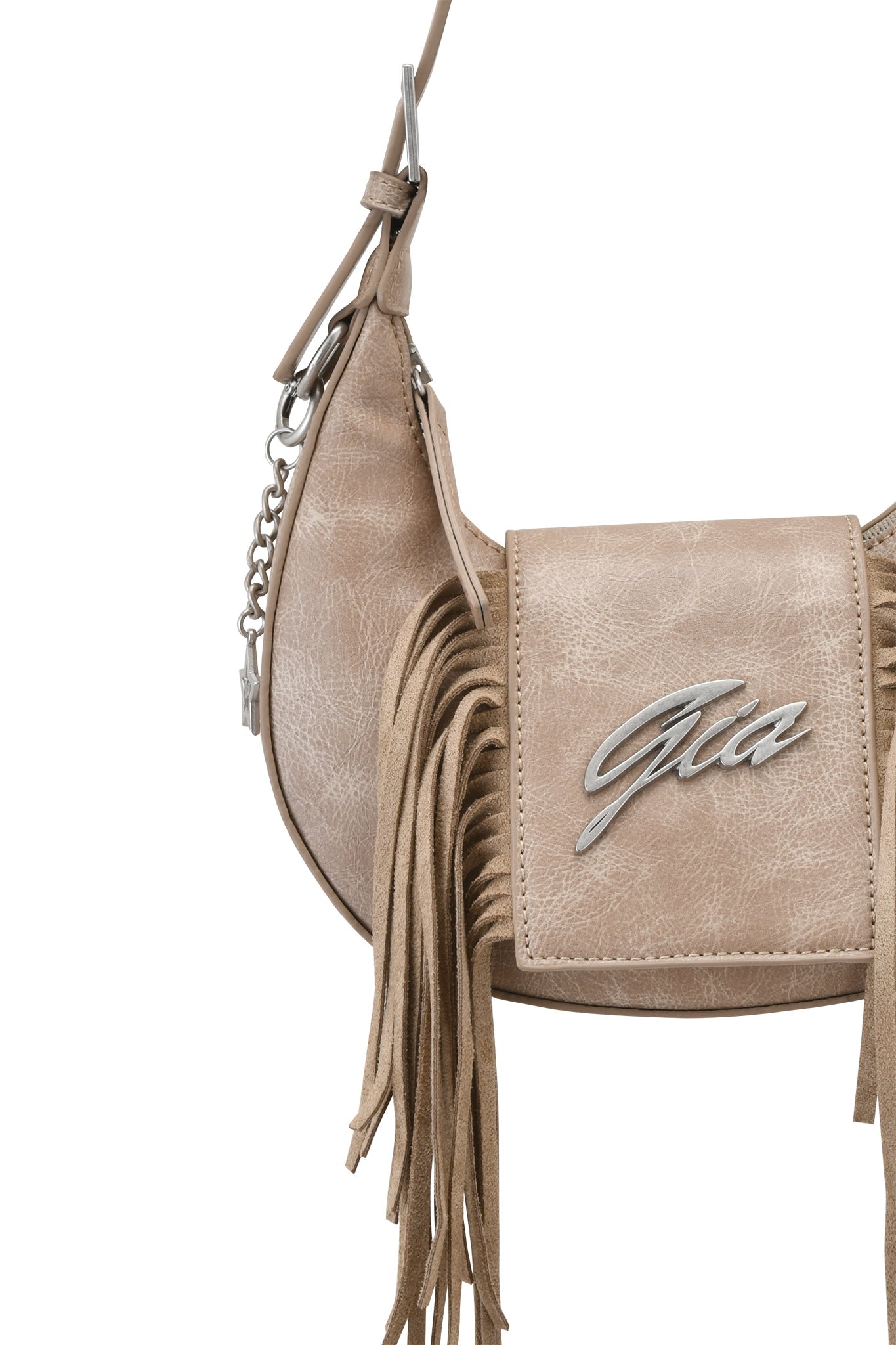 The TIA BAG - TAN FRINGE by I.AM.GIA features tan leather, silver hardware, a side strap, long fringe details, and a metal "Gia" logo on the front flap, displayed against a white background.