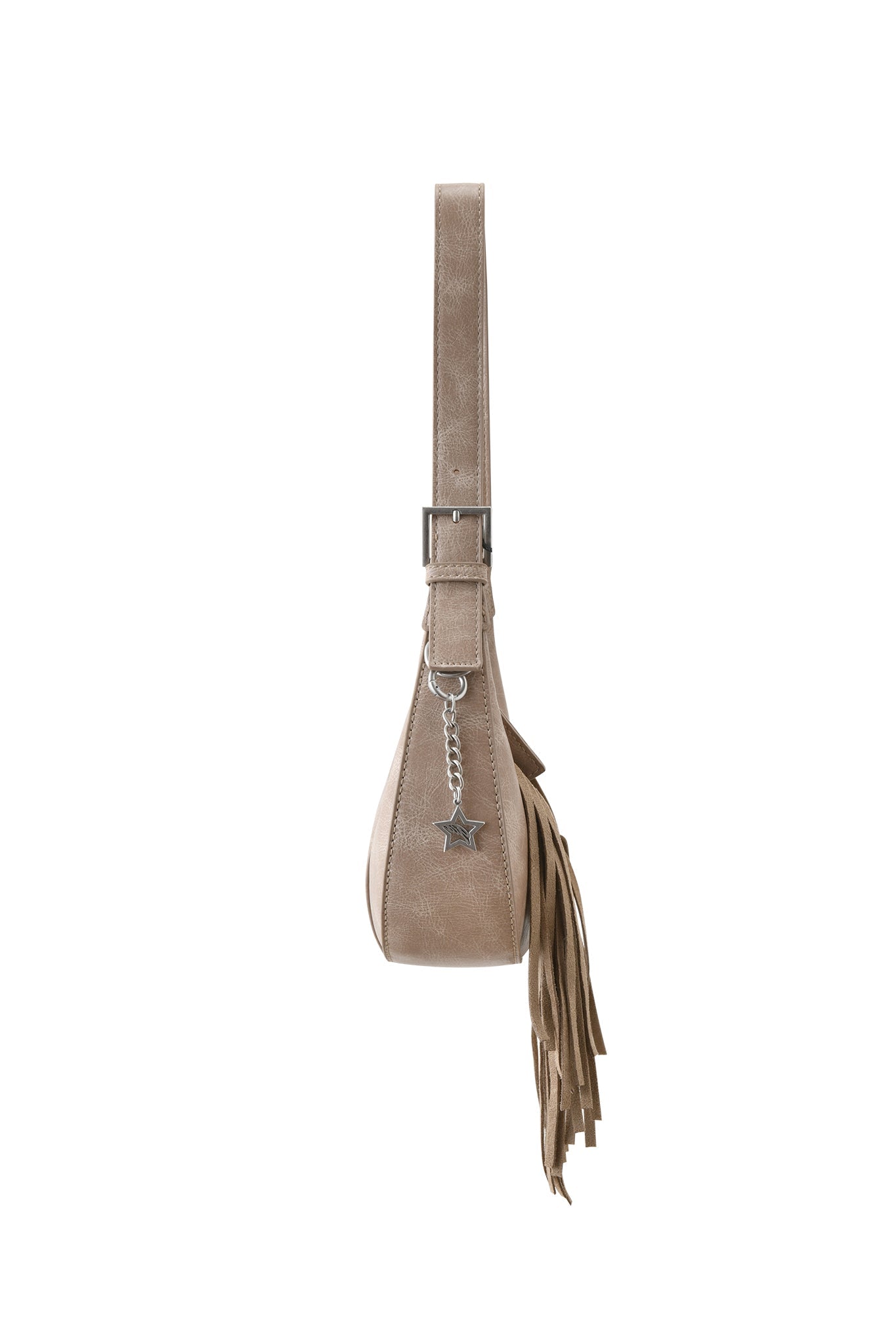 Side view of the I.AM.GIA TIA BAG - TAN FRINGE, featuring tan faux leather, a wide adjustable strap, side fringe accents, and a silver star charm on a chain. Bag shown against a plain white background.