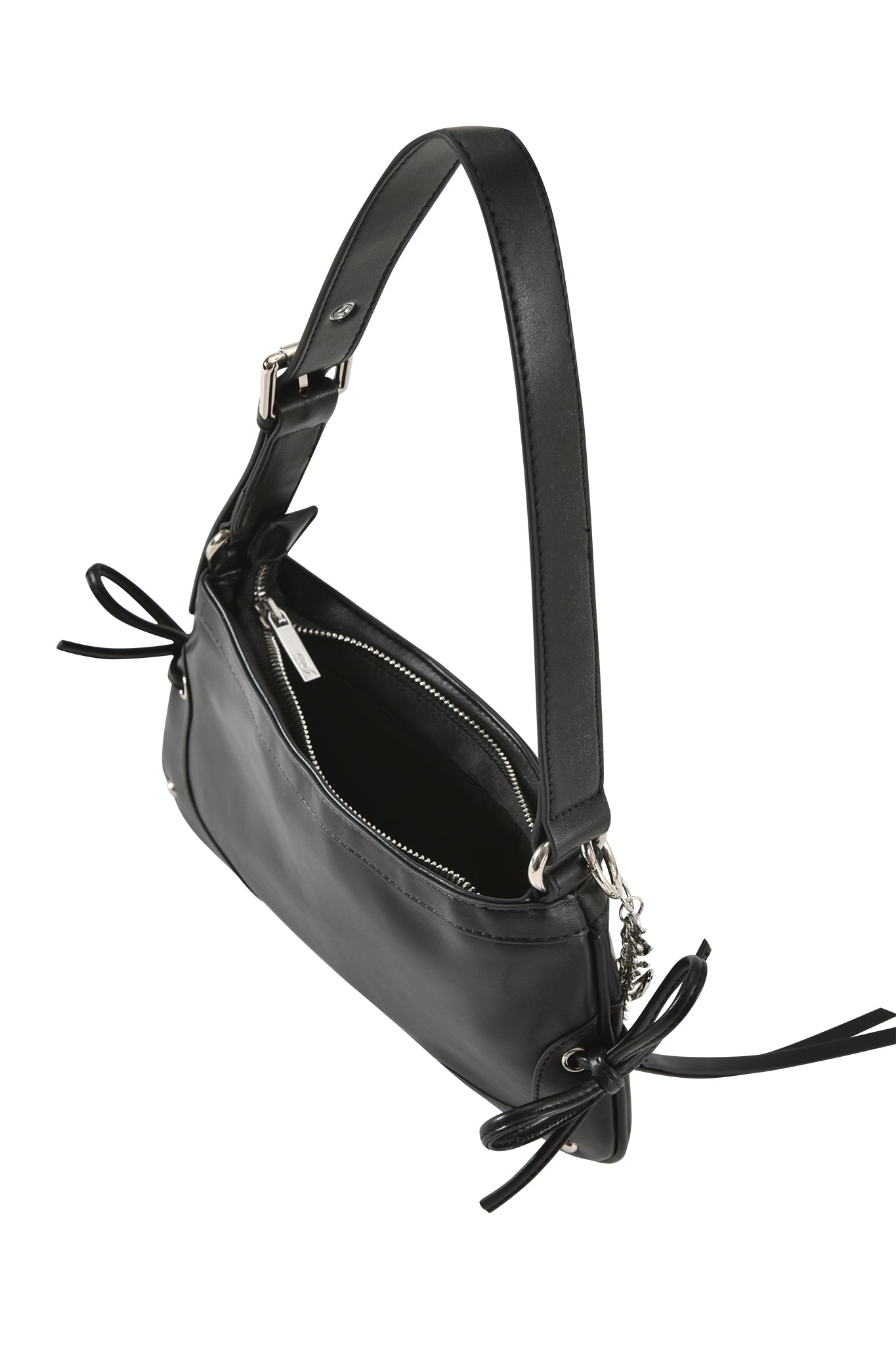 The HAYLEY BAG - BLACK by I.AM.GIA is a faux leather shoulder purse with a top zipper, adjustable strap, and decorative bows at each end, shown from an angled top view.