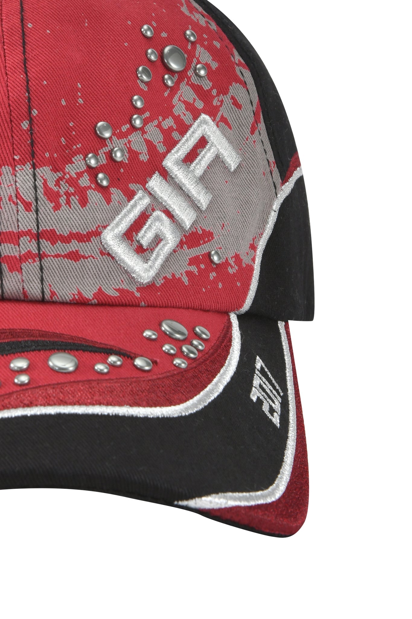 Close-up of the SERENA HAT - RED by I.AM.GIA, featuring red and black twill panels, silver embroidery, gray and silver splatter details, metallic studs, and a bold GIA logo stitched on the front.
