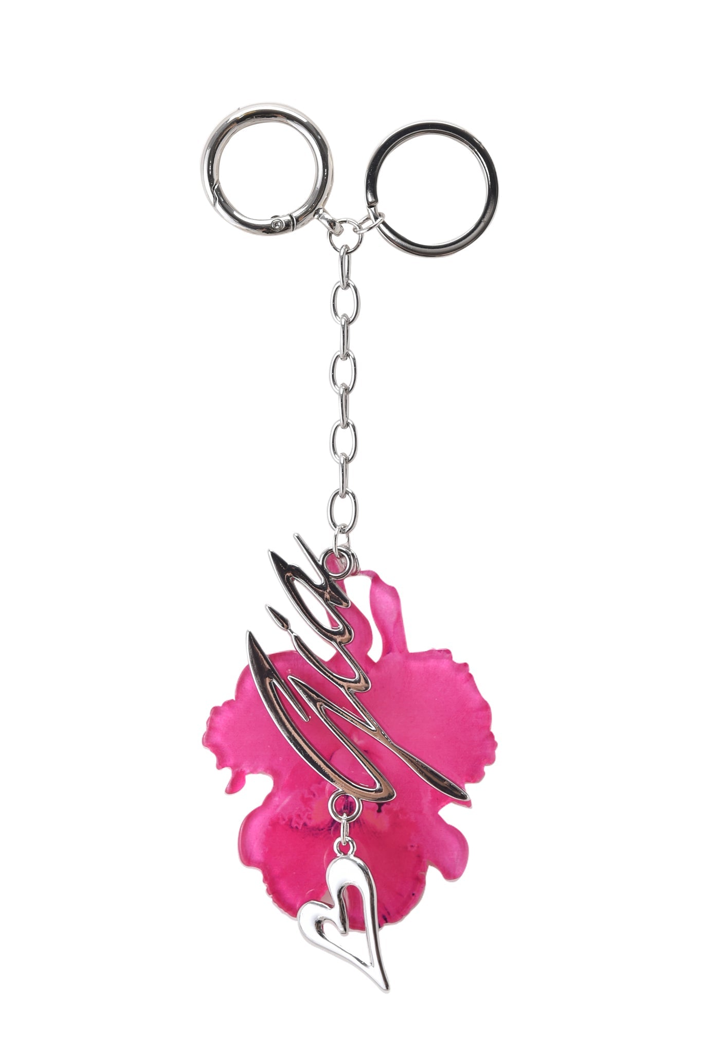 The ORCHID KEYCHAIN - NEON PINK by I.AM.GIA features a silver orchid flower charm, a neon pink flower-shaped accent, a silver GIA metal logo overlay, and a small heart charm all connected by a short chain.