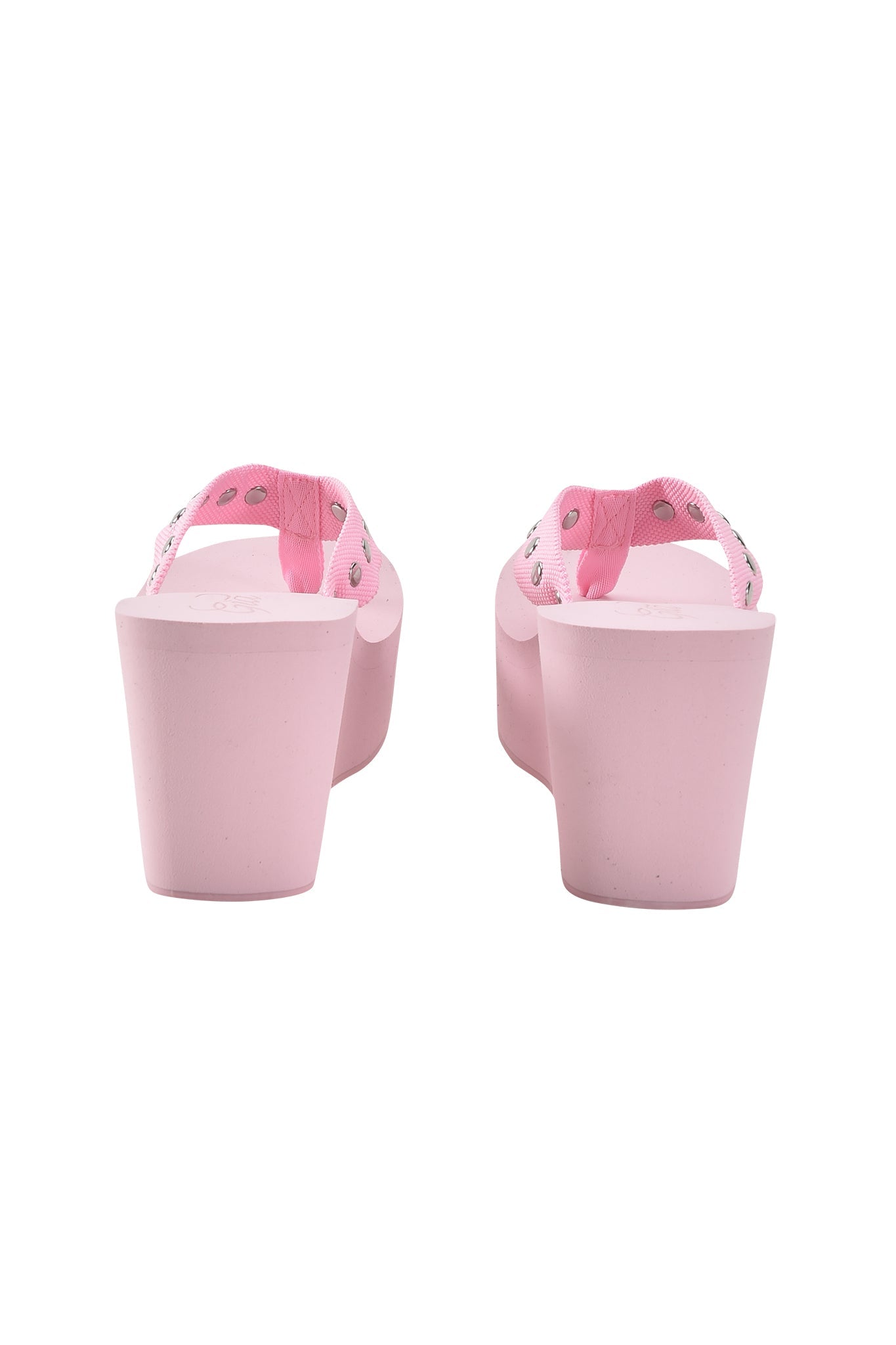 The SHELBY STUDDED FLIP FLOP 2.0 in Baby Pink by I.AM.GIA features pink fabric straps with silver studs and light pink wedge soles, shown from the back on a white background—ideal for platform sandal lovers.