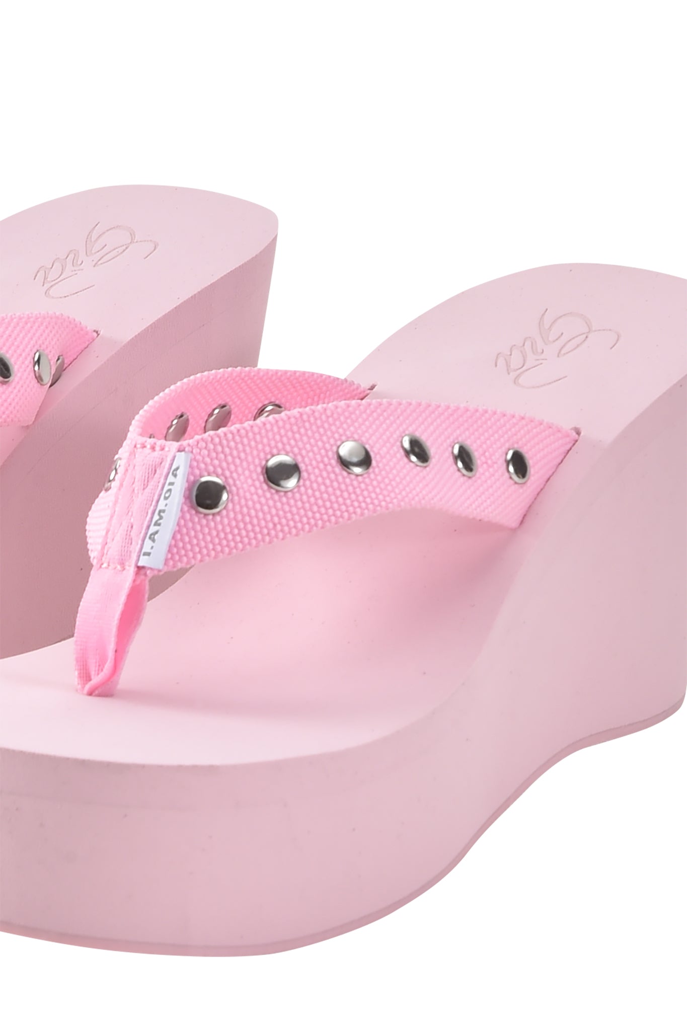 The SHELBY STUDDED FLIP FLOP 2.0 - BABY PINK by I.AM.GIA features thick platform soles, pink fabric straps with silver studs, and a small white label.