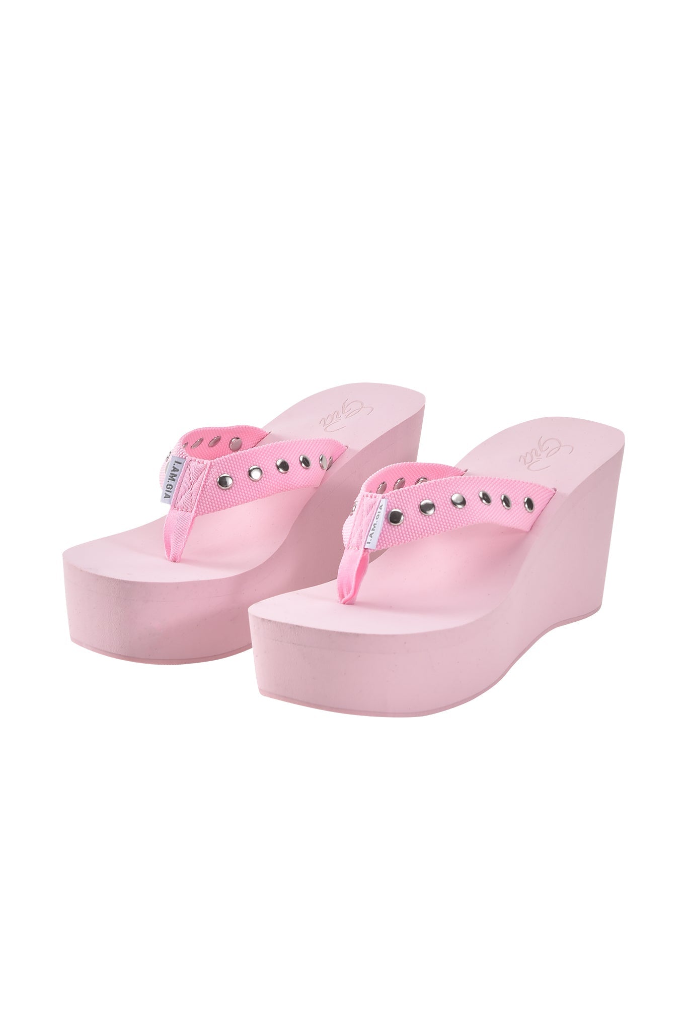 The SHELBY STUDDED FLIP FLOP 2.0 in baby pink by I.AM.GIA features studded straps and a platform wedge, shown on a white background.