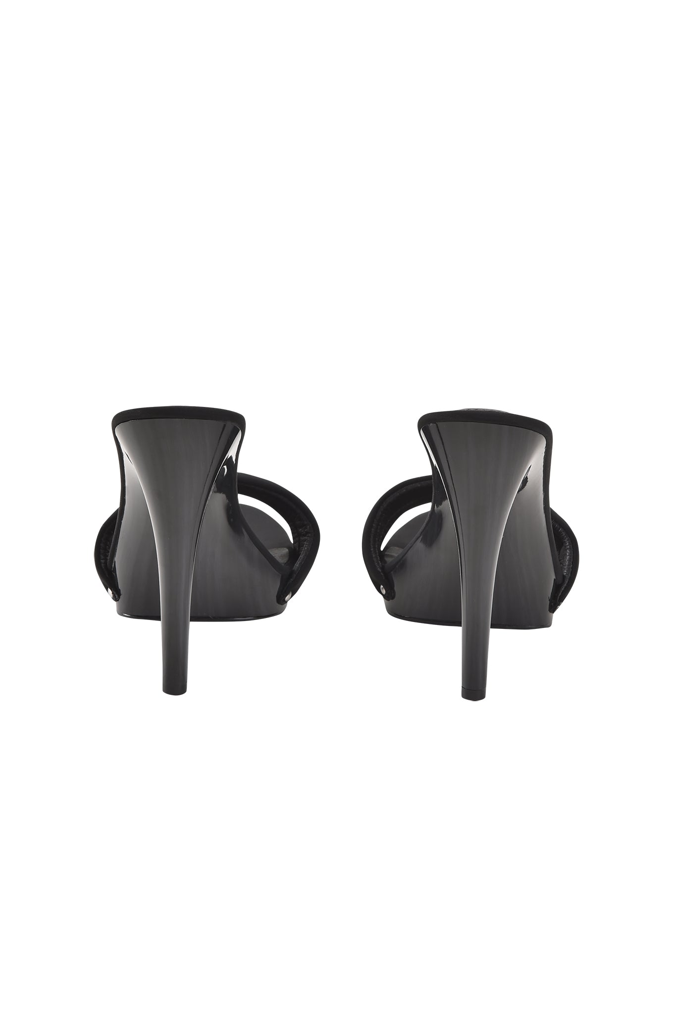 The NICKY HEEL - BLACK NEOPRENE by I.AM.GIA features slip-on black stiletto mules shown from the back, highlighting slim tapered heels, open curved sides, and a padded vamp strap for comfort.