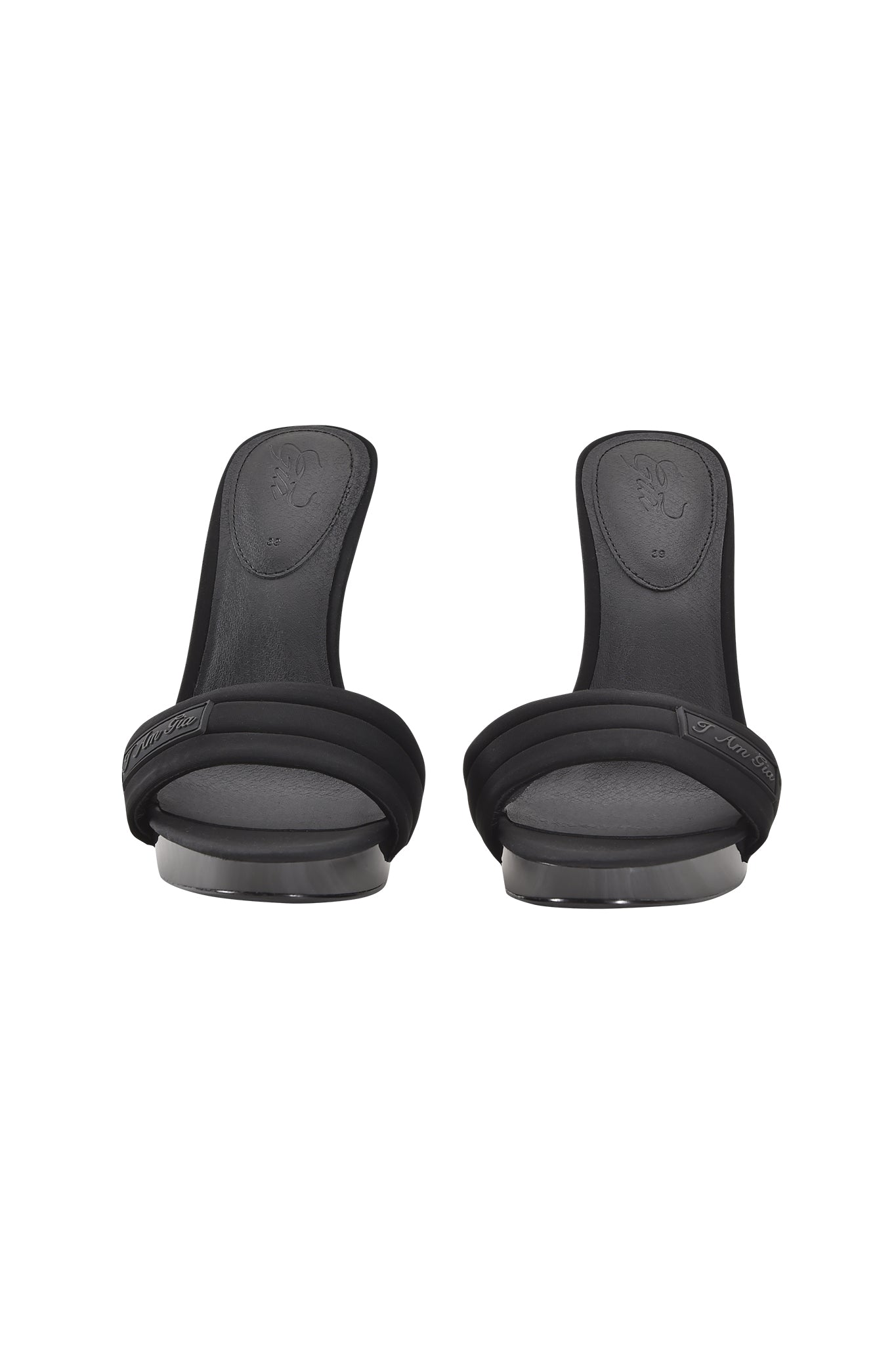 The NICKY HEEL - BLACK NEOPRENE by I.AM.GIA is a pair of black slip-on mule sandals featuring a padded vamp strap and glossy heel base, shown from the front against a white background.