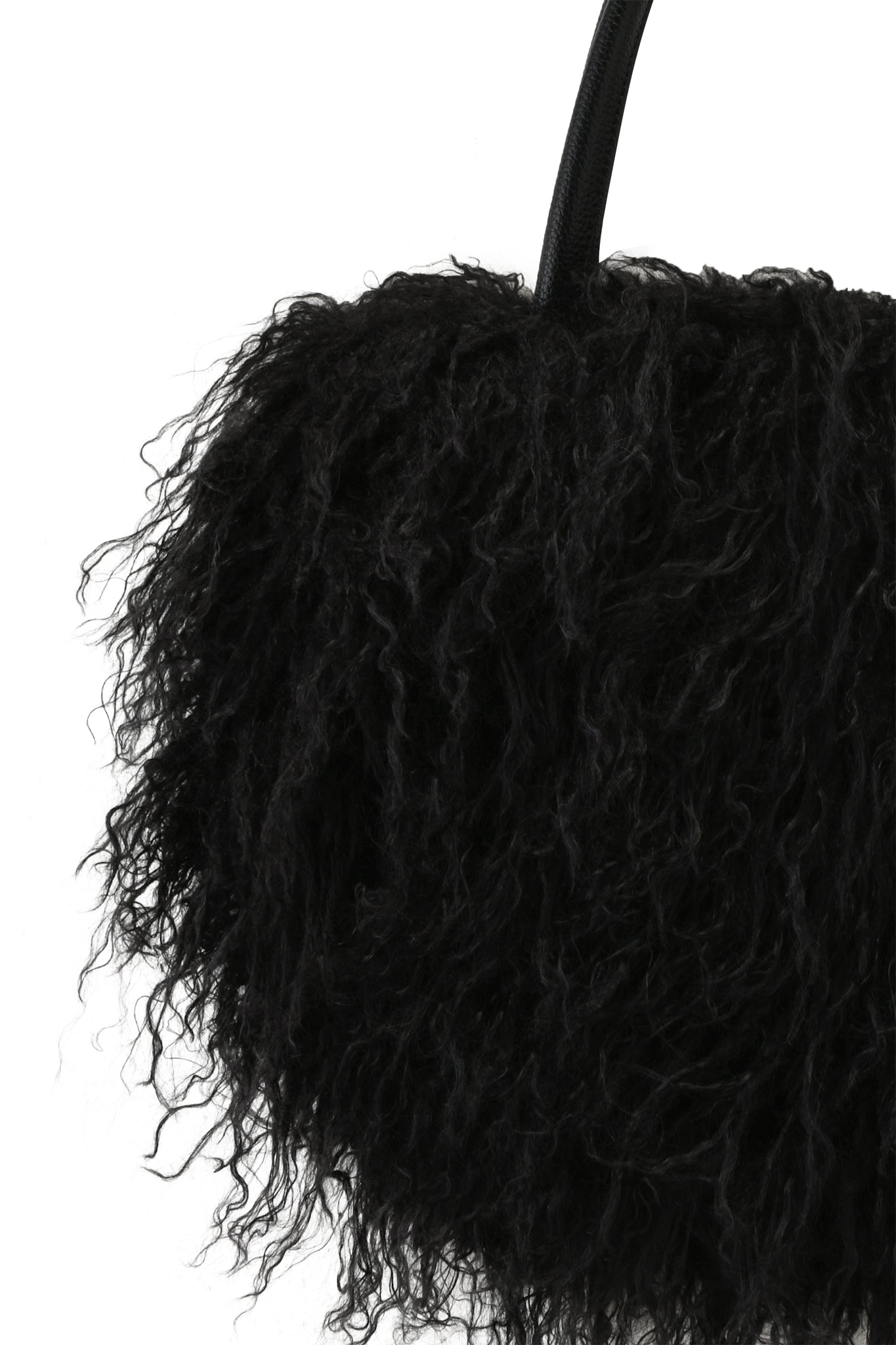 Close-up of the I.AM.GIA PIXI FAUX FUR BAG - BLACK, featuring a textured, shaggy, curly surface and top handle. Shown against a white background, this oversized shoulder bag brings bold style to any look.