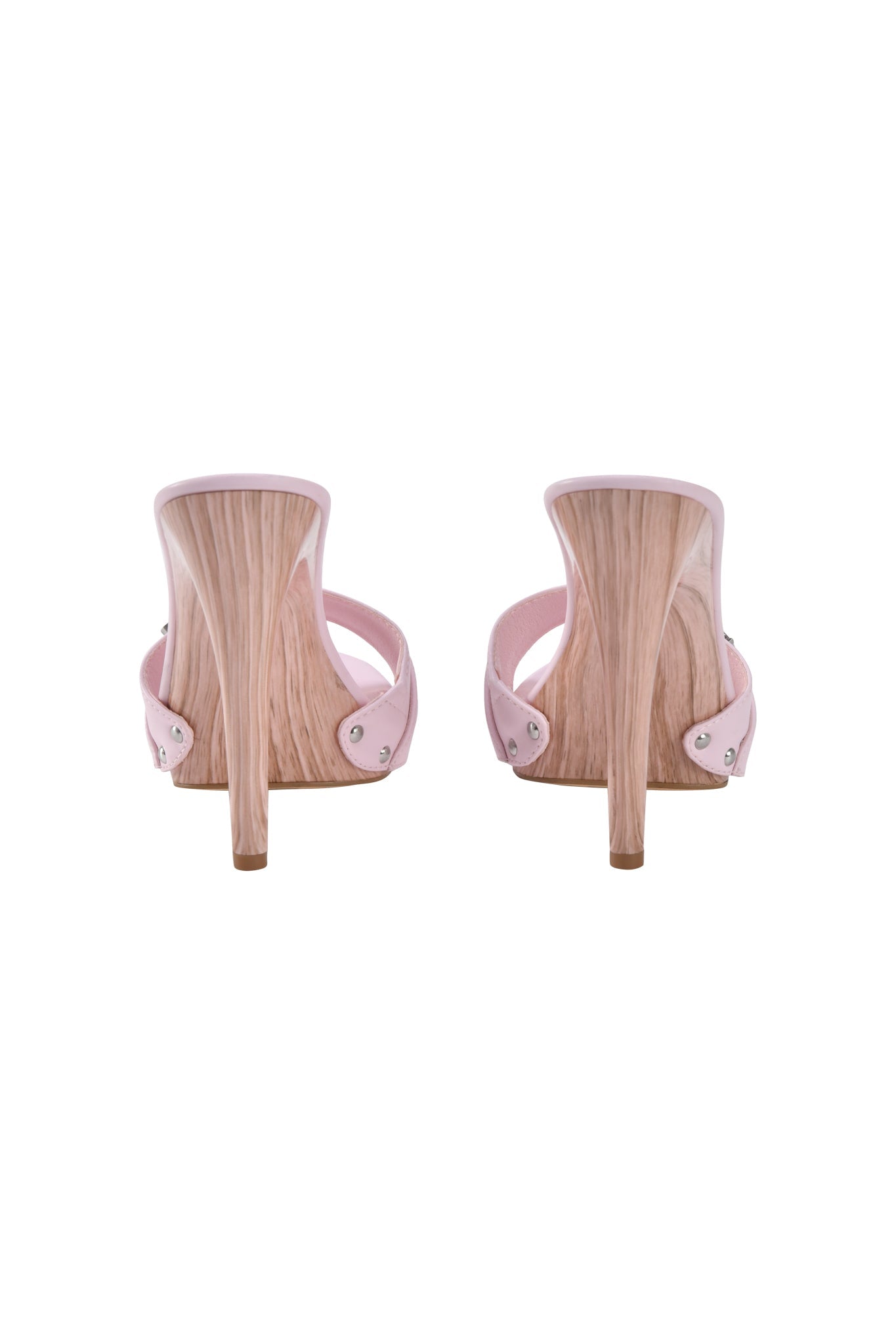 The NICKY HEEL - STUDDED BABY PINK by I.AM.GIA showcases light pink faux leather and wooden-textured stiletto heels, viewed from the back against a white background.