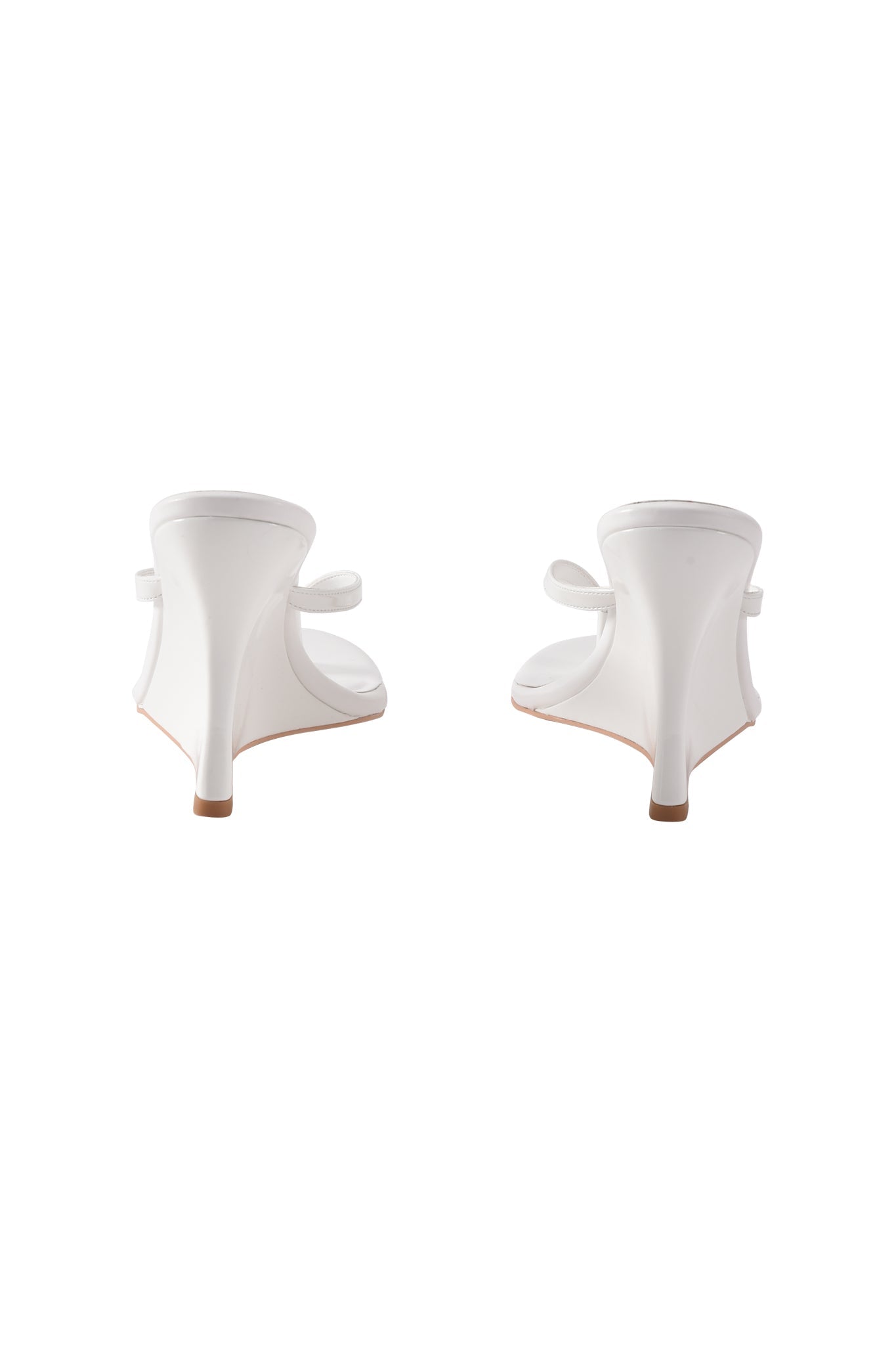 The I.AM.GIA VIKTORIA WEDGE HEEL in white features open heels, thin ankle straps, and flared block heels in faux leather, shown from the back against a white background.