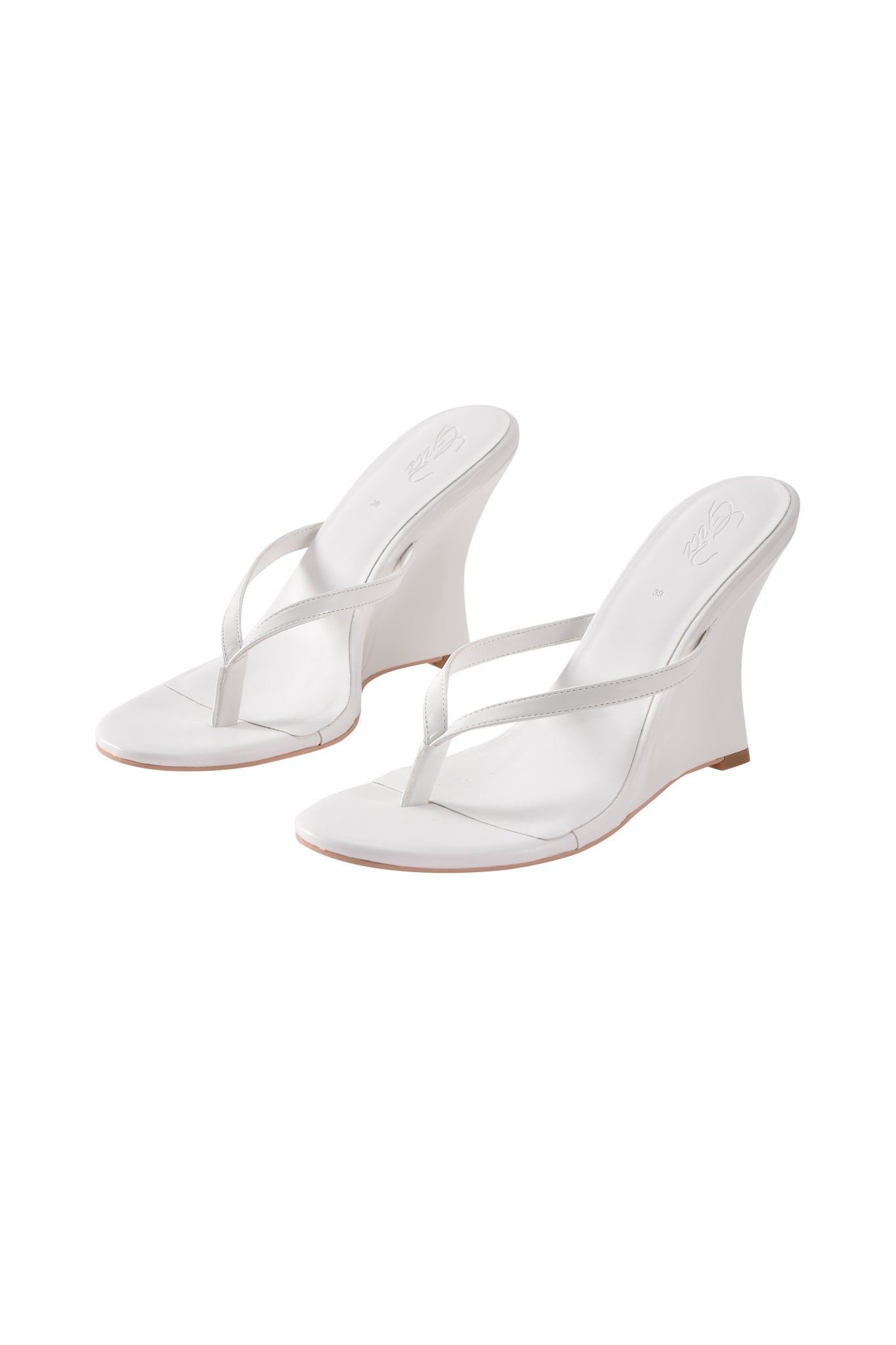 The I.AM.GIA VIKTORIA WEDGE HEEL in white features faux leather, thin straps, a thong design, wedge heels, and open toes, shown against a plain white background.