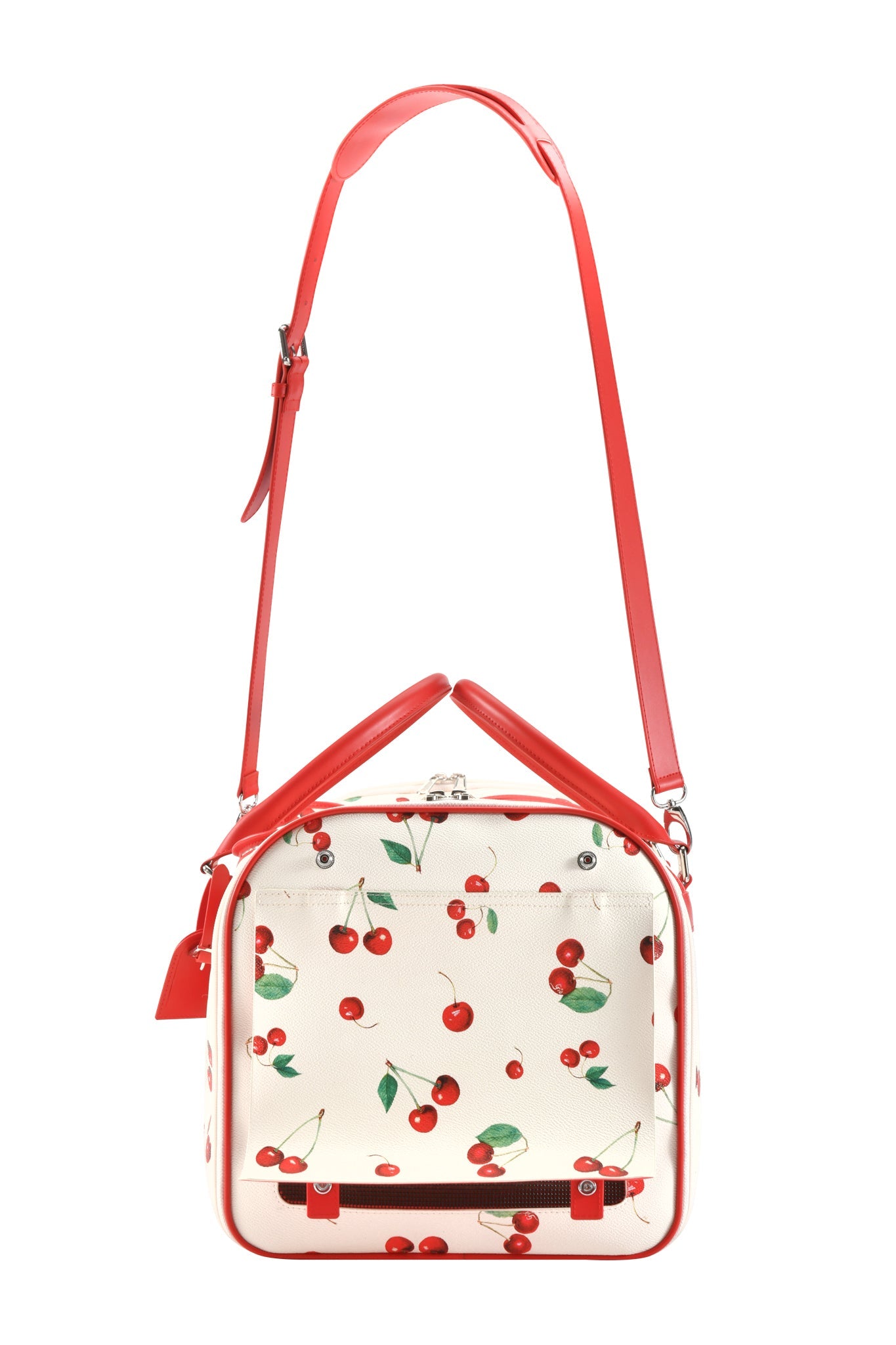The TRIXX PET CARRIER - CHERRY ON TOP by I.AM.GIA is a square, boxy dog bag with a playful cherry print on white, red adjustable shoulder strap and handle, and silver hardware for style and function.
