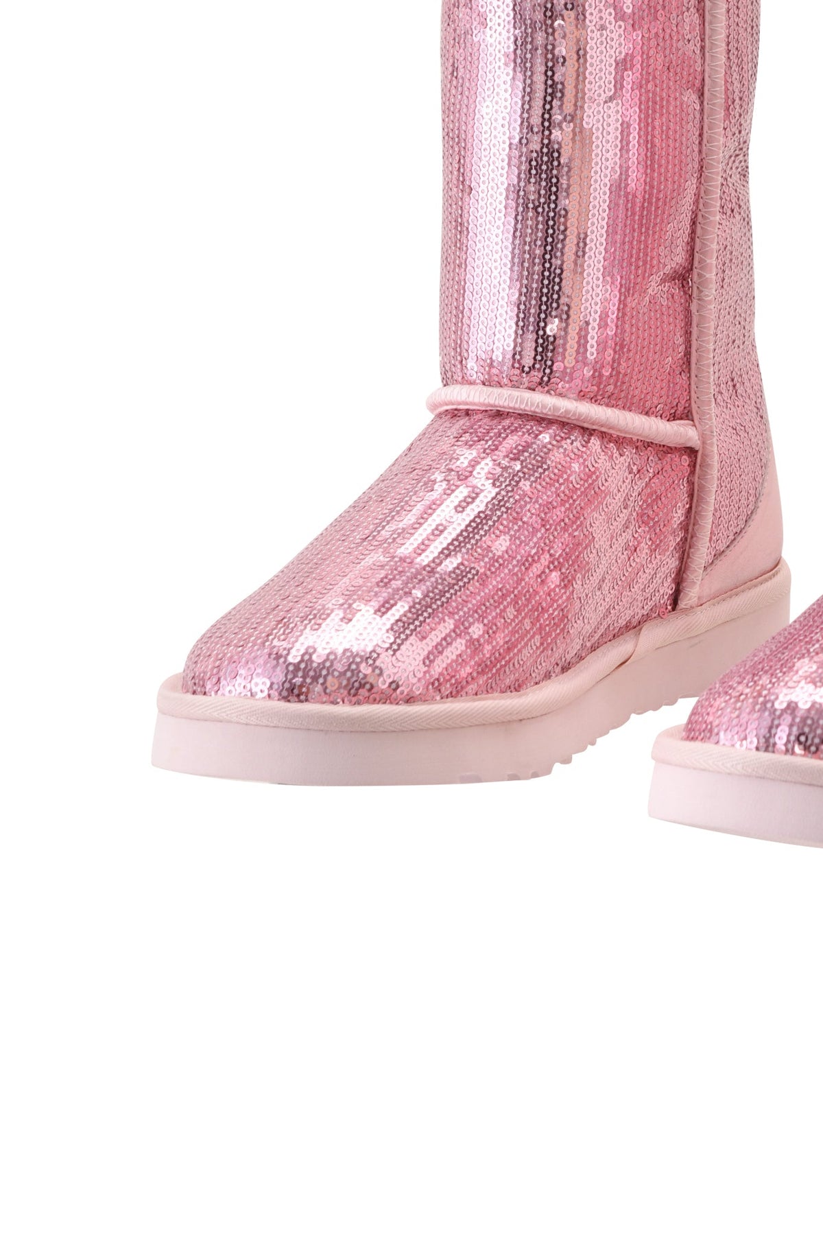 The ELVIRA SEQUIN BOOT - PINK by I.AM.GIA is a pair of tall pink sequin boots with flat soles, rounded toes, and a cozy faux fur lining, displayed against a white background.