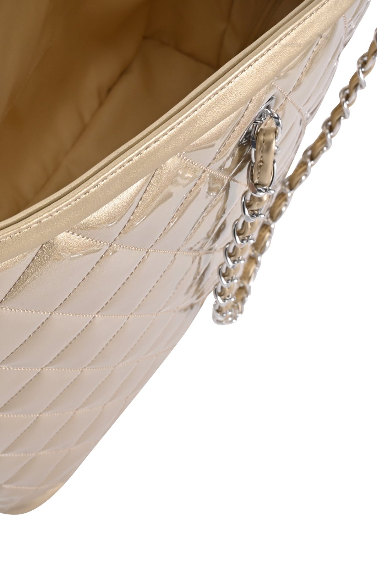 Close-up of the I.AM.GIA DANNI TOTE BAG - GOLD, showcasing its metallic gold quilted detailing, chain link straps, and shiny finish, with a glimpse of the interior that highlights the exquisite stitching.