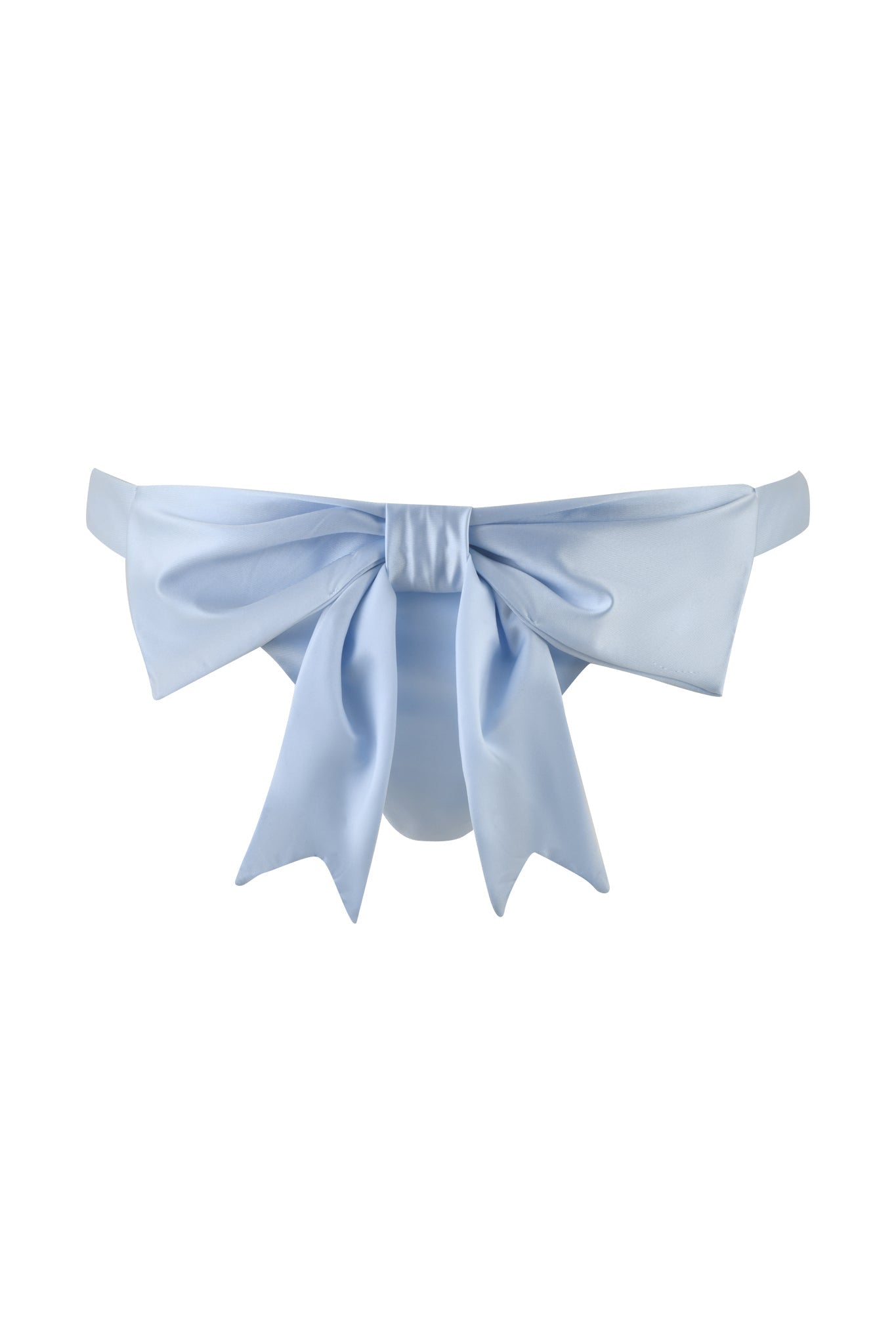 The DELPHINA BIKINI BOTTOM - BLUE : BABY BLUE from I.AM.GIA features a prominent decorative bow at the front, centrally tied with elegant trailing ends. The fabric provides a smooth and shiny finish, while the cheeky back coverage adds a playful element.