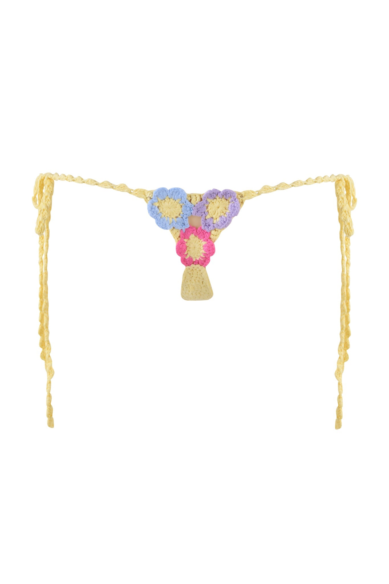 The BLOSSOM BIKINI BOTTOM by I.AM.GIA is a yellow crochet thong with a flower motif, featuring braided and adjustable side ties. The small triangle front is adorned with pastel-colored crocheted flowers for a delicate touch.