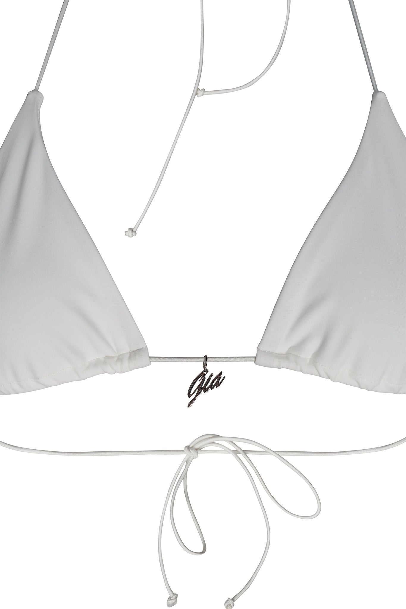 A close-up view of the BAMBI BIKINI TOP - WHITE, featuring thin string ties with adjustable knots and a small metallic charm with the name "Gia" hanging at the center. This bikini top from I.AM.GIA showcases their signature style with its unadorned, simple design.