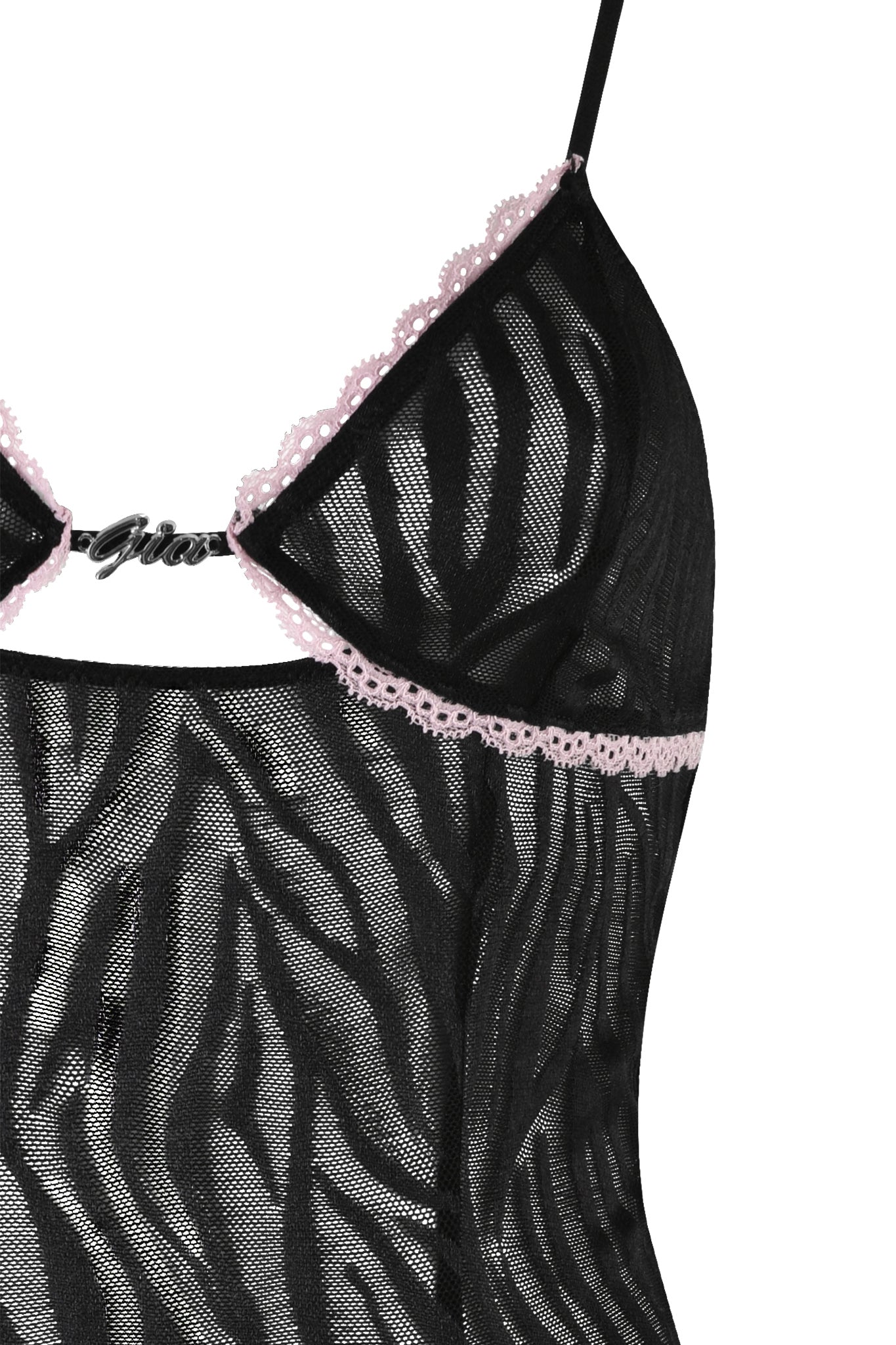 A close-up of the TARAJI SLIP DRESS - BLACK : ZEBRA by I.AM.GIA reveals a sheer black and gray zebra-print design with pink lace trim. The delicate material presents a scalloped edge, complemented by thin adjustable shoulder straps, enhancing its bodycon silhouette for a stunning look.