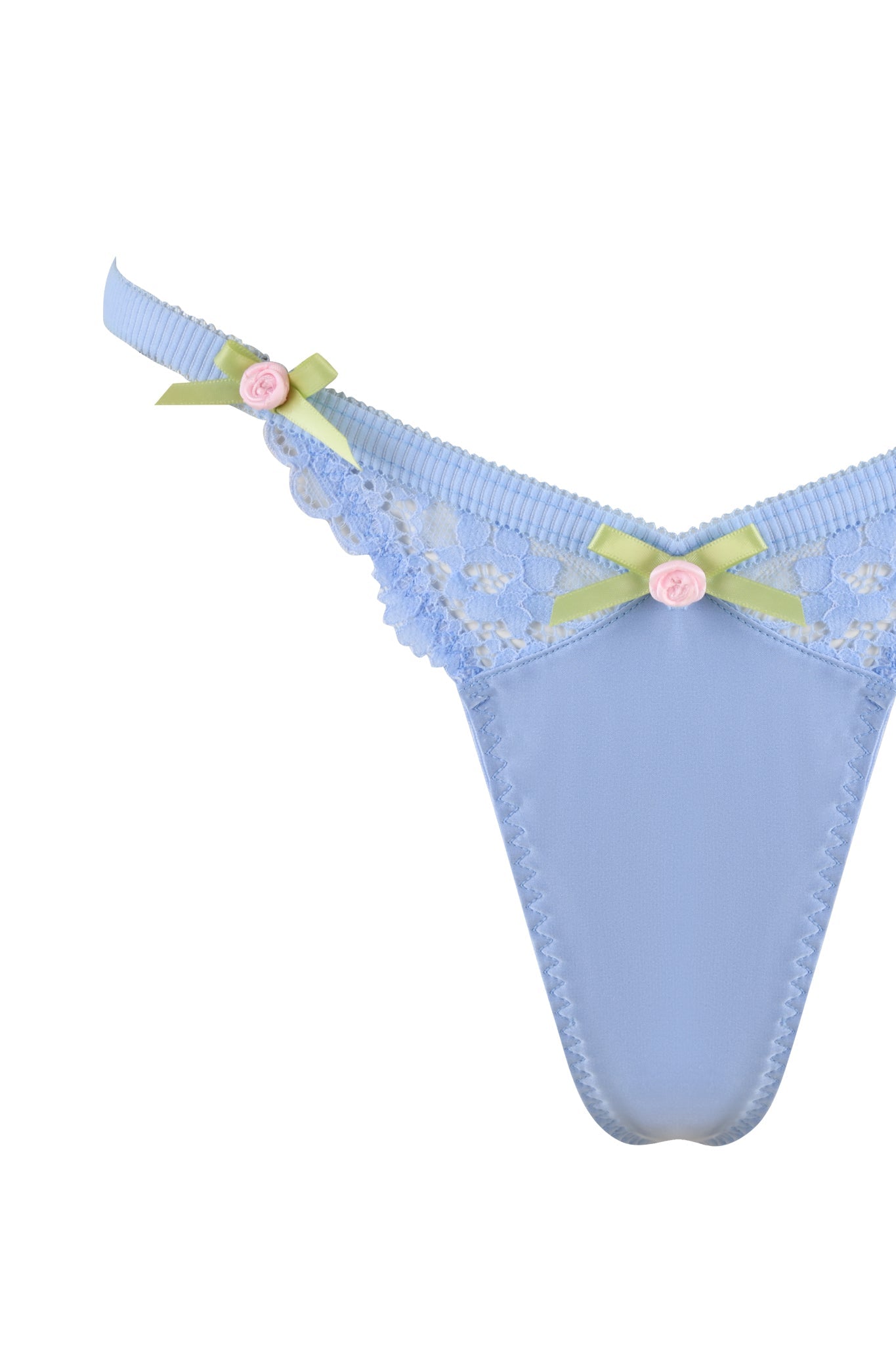 The CALLISTA SET - BLUE by I.AM.GIA features a light blue thong embellished with delicate lace detailing and green ribbon bows, adorned with small pink roses on the straps. The silky fabric boasts a subtle shine, perfectly complemented by floral-patterned lace trims.