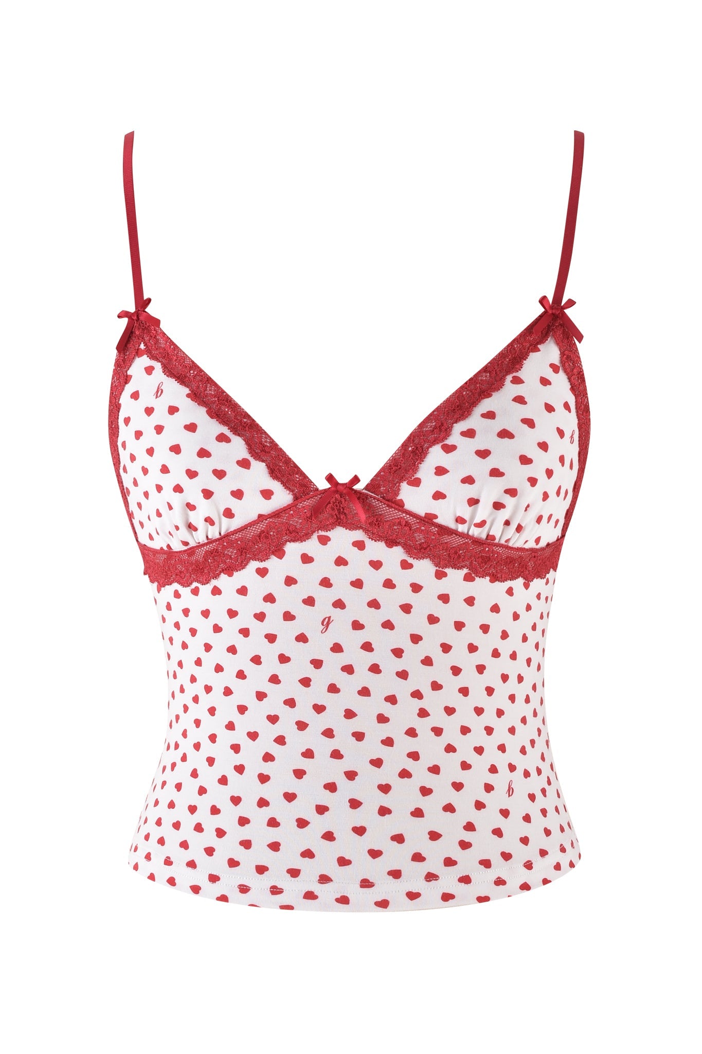 The KENDRA TANK from I.AM.GIA is a white camisole with adjustable red spaghetti straps, adorned with small red heart patterns. The neckline has red lace trim and features small bows at each strap connection for a delicate, playful look.