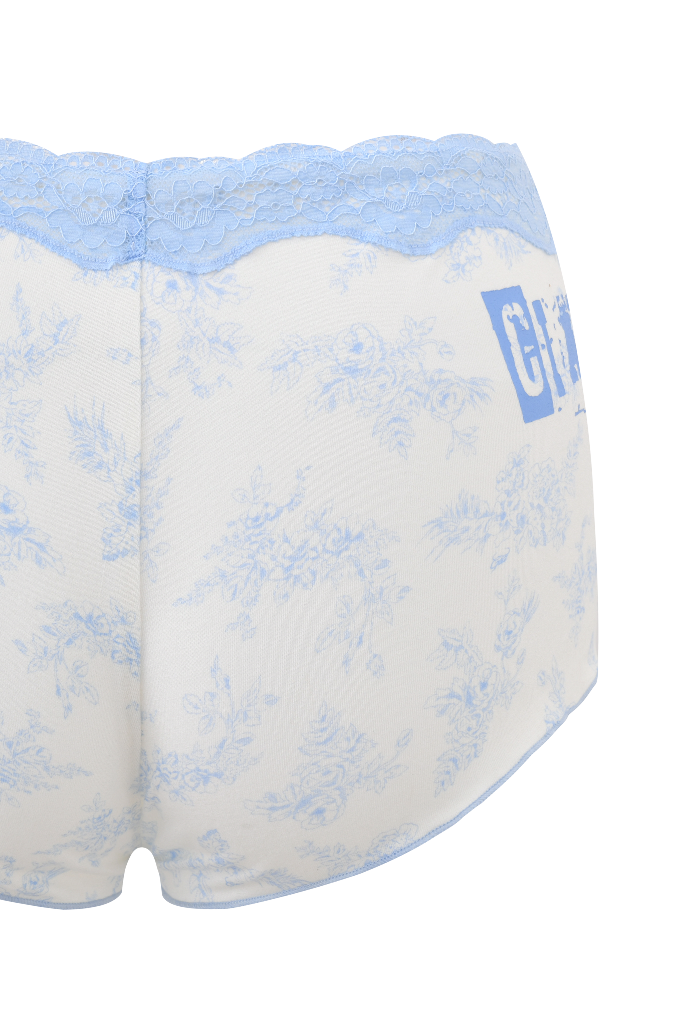 The I.AM.GIA CASSIA SHORT - BLUE TOILE is a pair of white women's shorts with light blue lace trim, a blue toile floral print, and partially visible "girls" text on the right side.