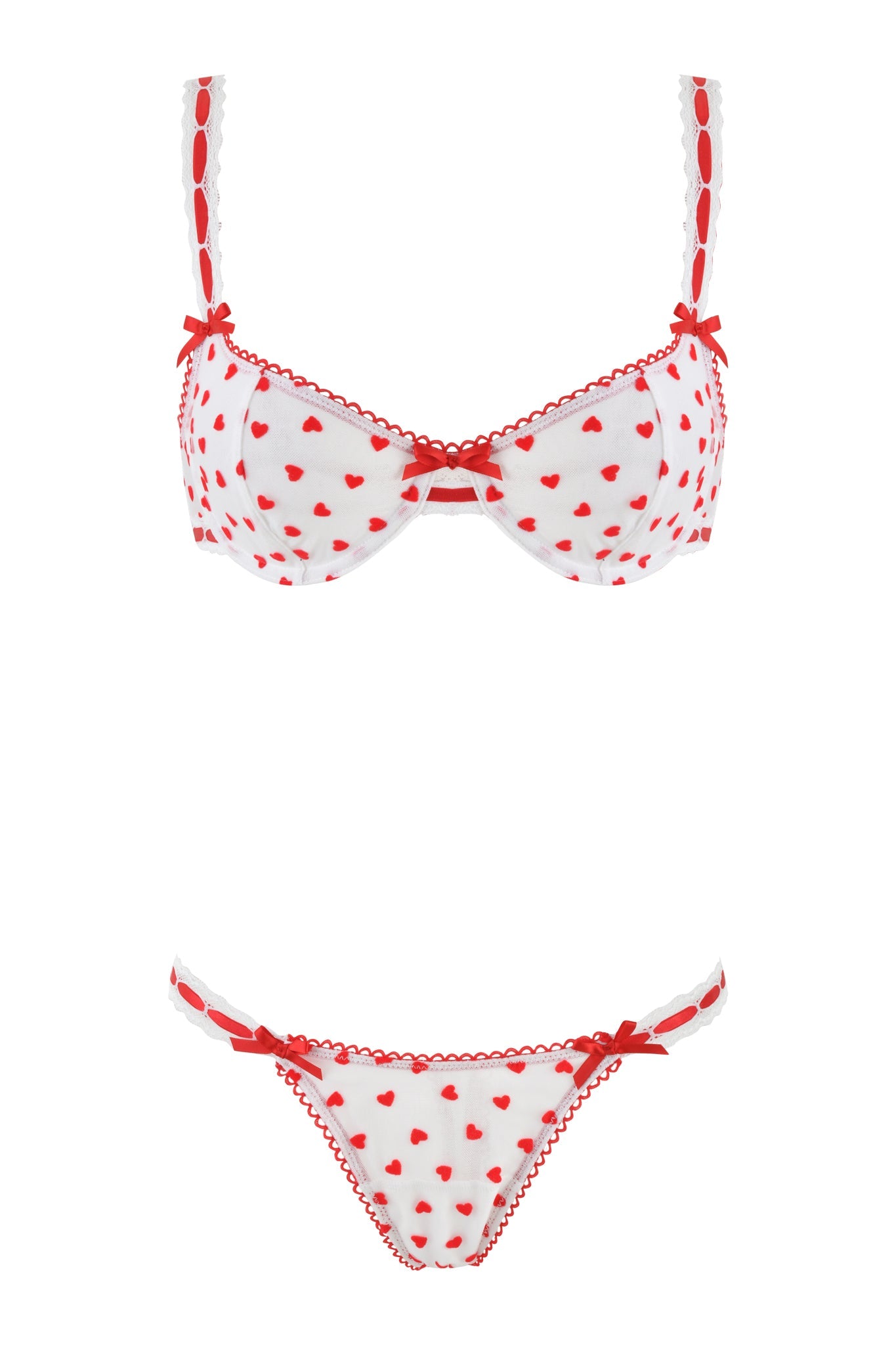 The ROMY 2 PIECE SET - WHITE: HEARTBEAT by I.AM.GIA is a white lingerie ensemble with red heart patterns, featuring an underwire bra embellished with small red bows and delicate lace trim on the straps, center, and panties' hips.