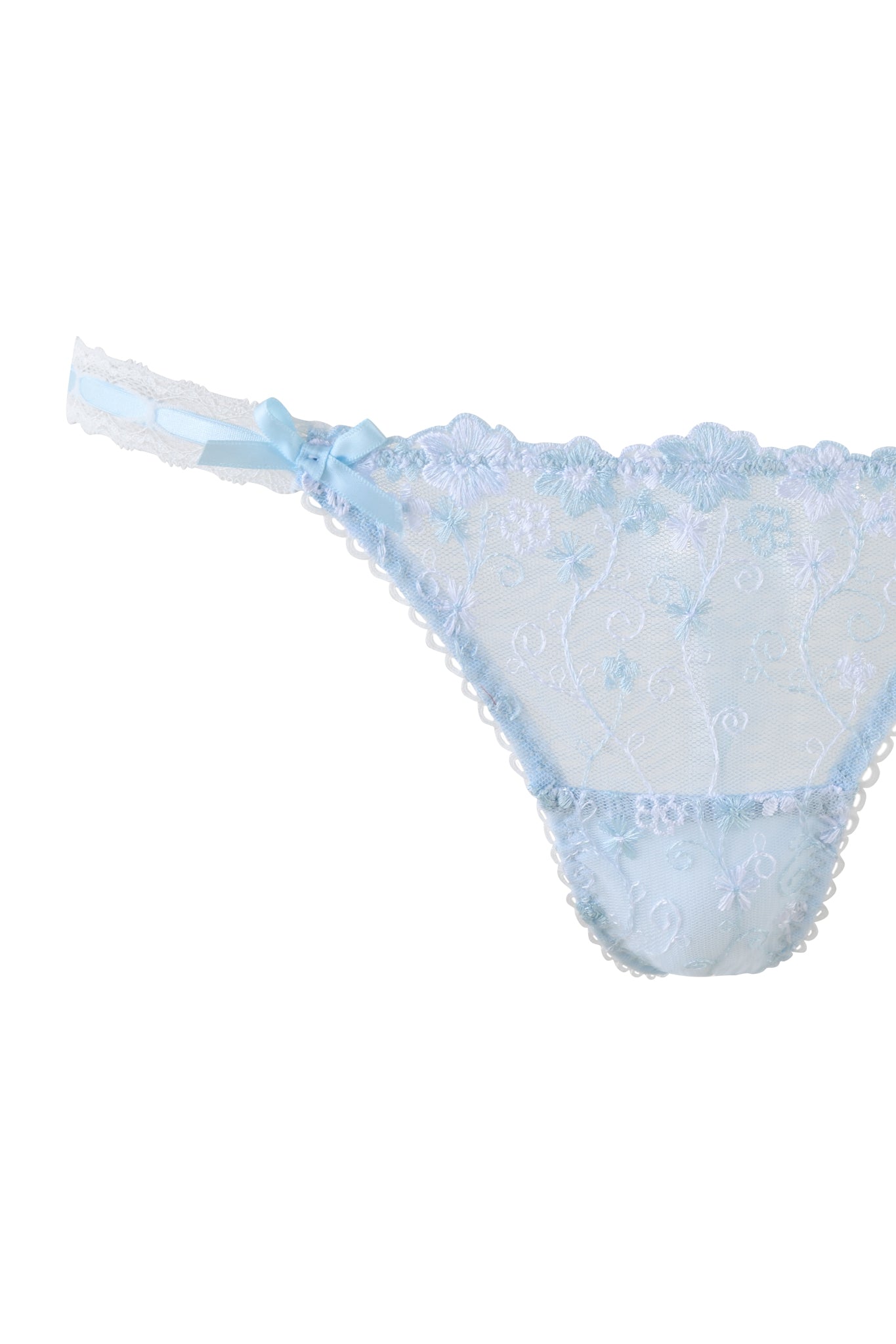 The ROMY 2 PIECE SET - BLUE by I.AM.GIA is a light blue lacy underwear set with embroidered daisy lace, a small bow on the waistband, sheer fabric, intricate patterns, scalloped edges, and adjustable waist straps for a perfect fit.