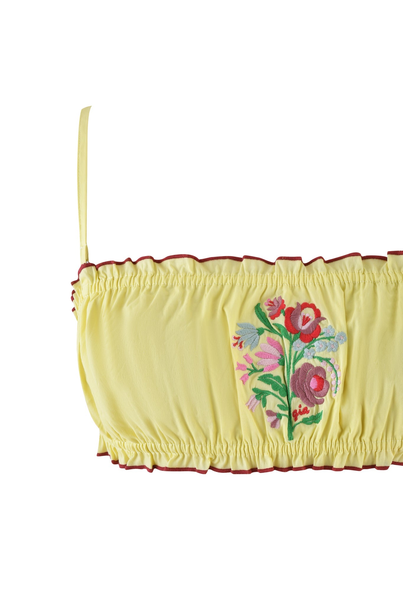 The CLOVER SET - YELLOW by I.AM.GIA includes a yellow ruched top with spaghetti straps, red trim, and floral embroidery in red, pink, and green. It perfectly pairs with a bandeau bralette for a coordinated look.