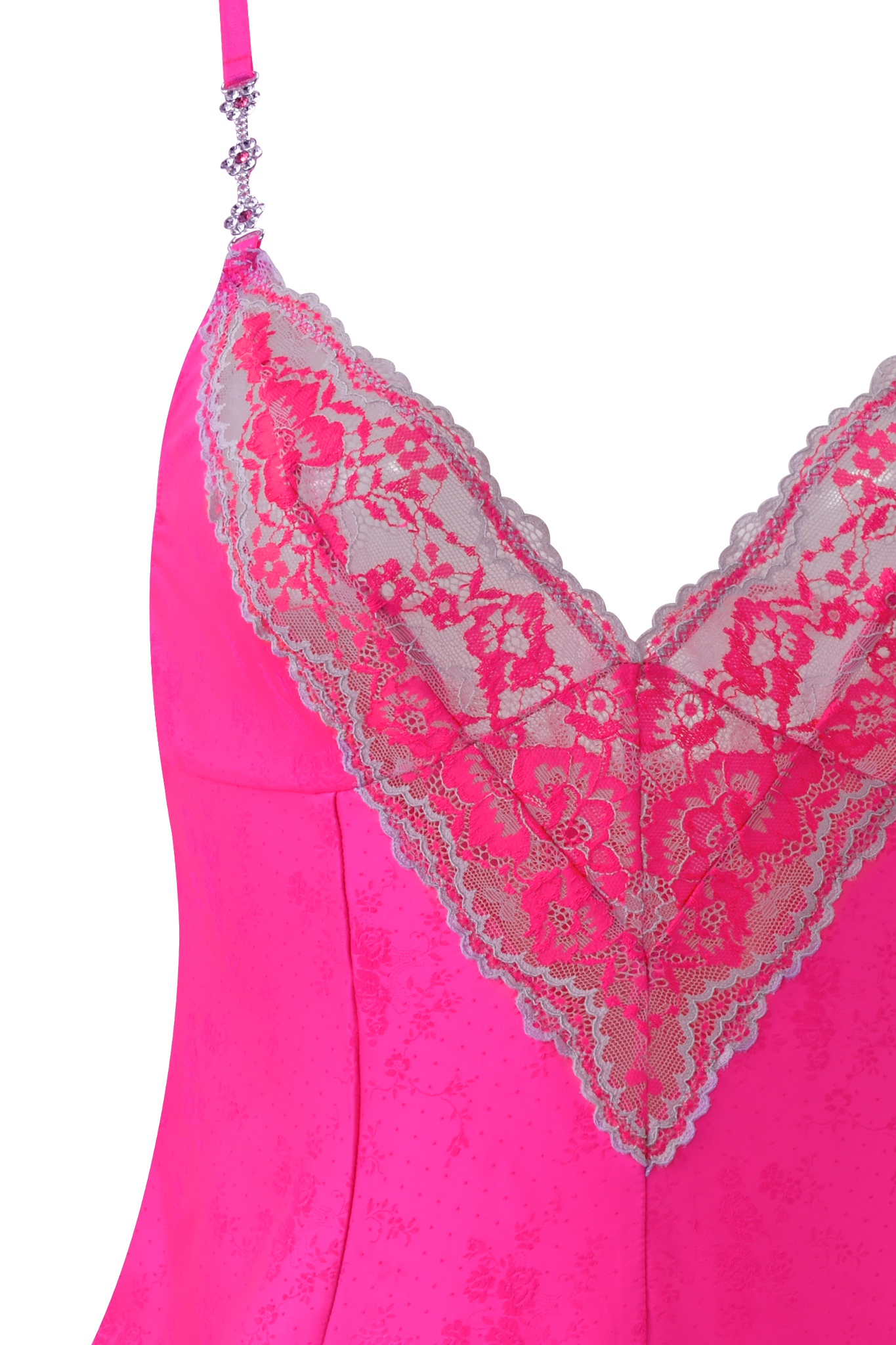 Close-up of the AMAYA CAMI SET by I.AM.GIA in neon pink, showing the soft satin fabric and deep V-neckline trimmed with sheer floral lace. Only the top part of this eye-catching cami is visible.