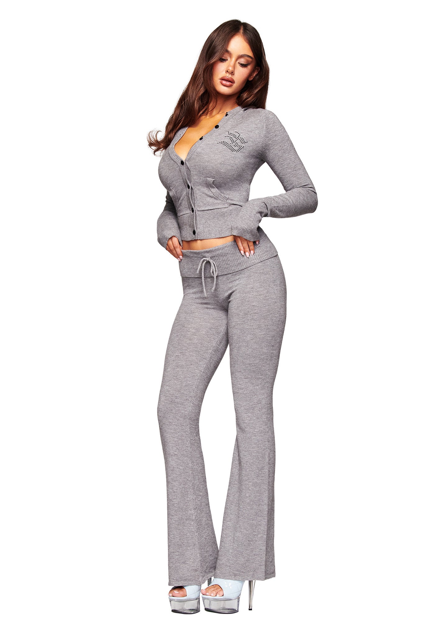 A woman models the I.AM.GIA JESSA HOODIE in grey, styled with matching flared pants and silver platform heels against a plain white background.
