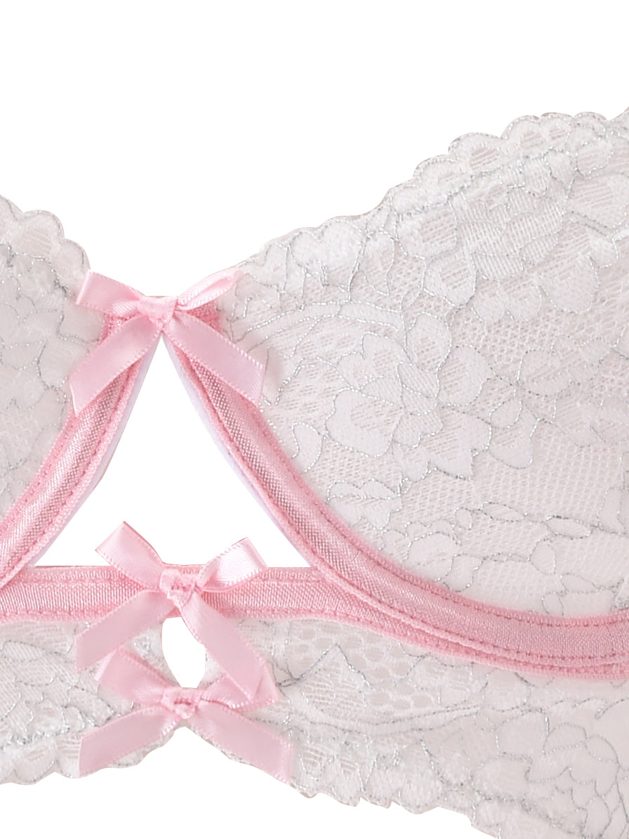 Close-up of the BUNNY LINGERIE SET - WHITE PINK by I.AM.GIA, featuring a delicate white lace bra with light pink trimming. The vintage-inspired design showcases beautiful floral lace details and small pink bows.