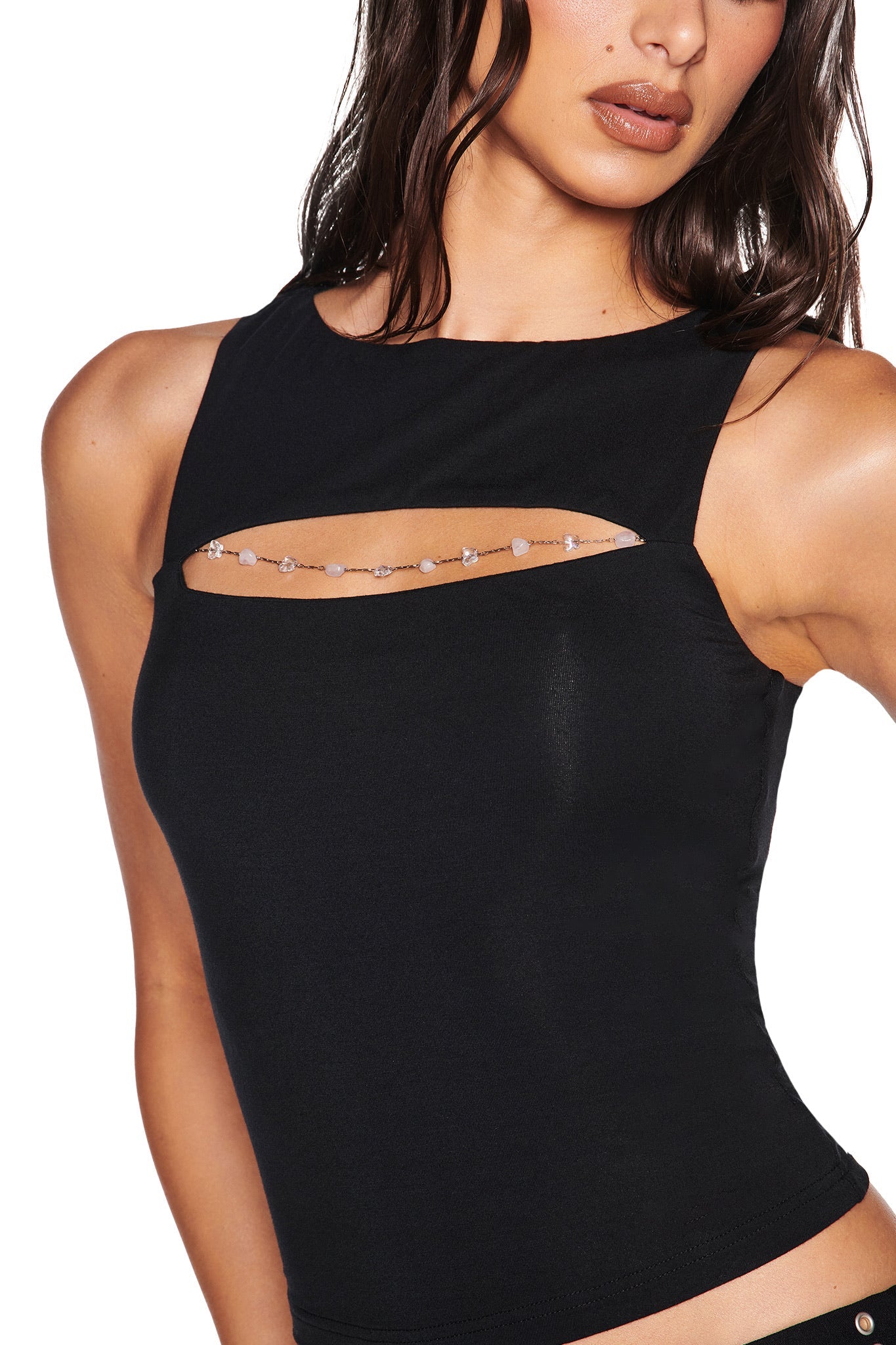 A woman wears the I.AM.GIA NOVENA TOP in black, featuring a front cut-out and decorative beads, crafted from soft bamboo jersey, shown against a plain white background.
