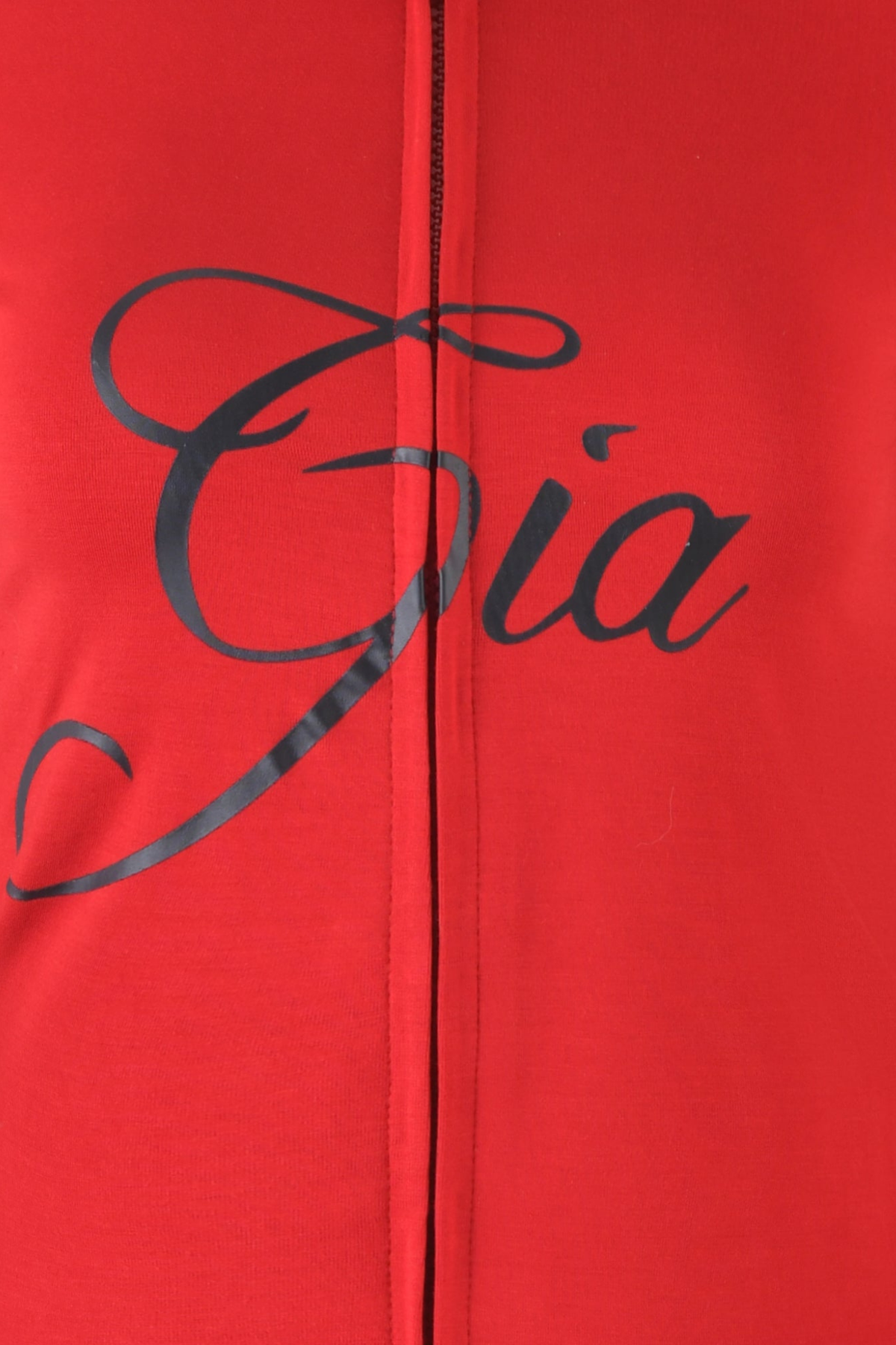 Crafted from red bamboo fabric, the BLARE HOODIE - RED by I.AM.GIA features the word “Gia” boldly emblazoned in large, black, elegant script across the center—evoking signature detail. A visible vertical seam runs down the middle, highlighting the refined construction characteristic of a Blare Hoodie.