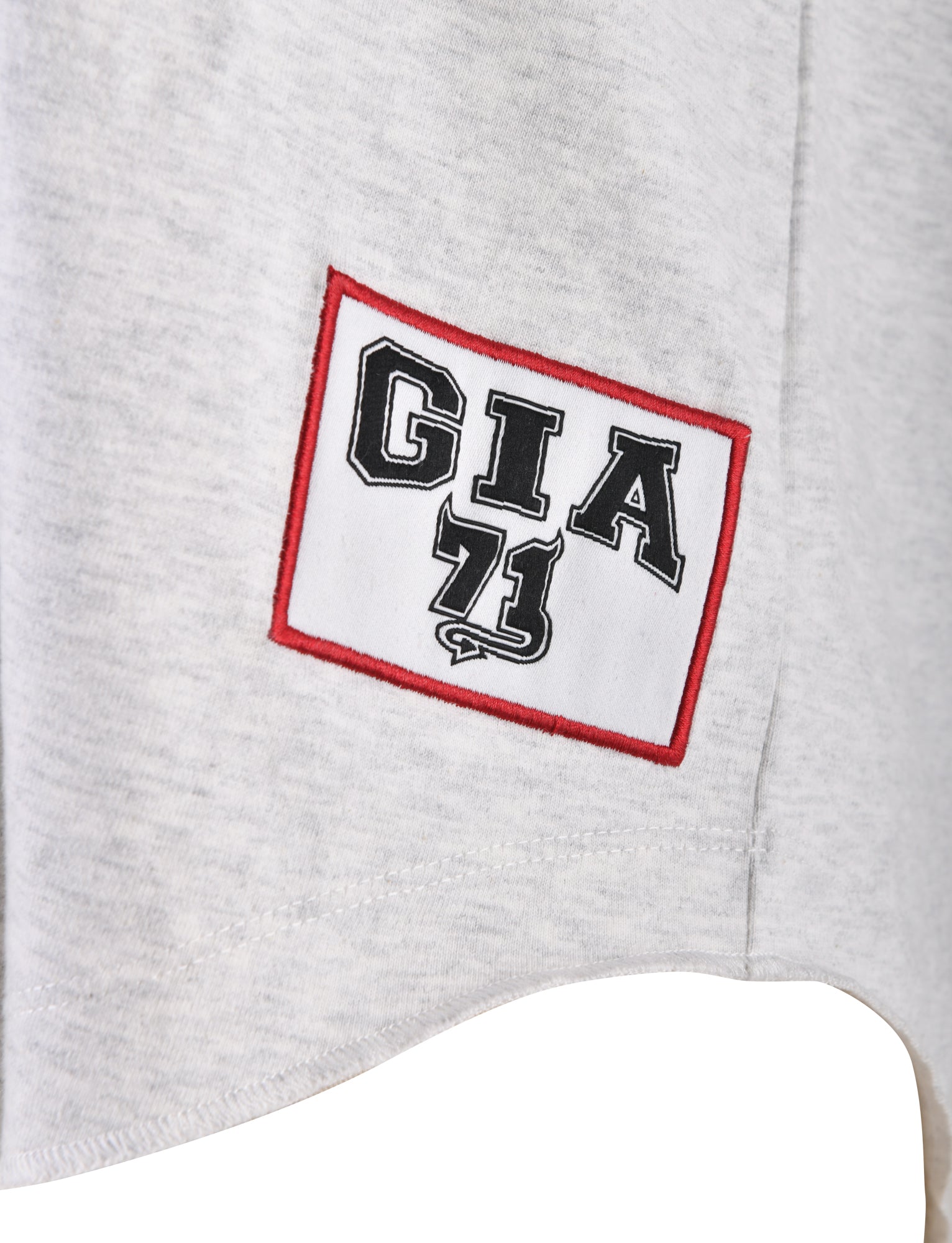 Close-up of the LORRI JERSEY - GREY from I.AM.GIA, showcasing a patch with the text "GIA 71" in bold black letters inside a white rectangle outlined in red, exemplifying I.AM.GIA’s distinctive style.
