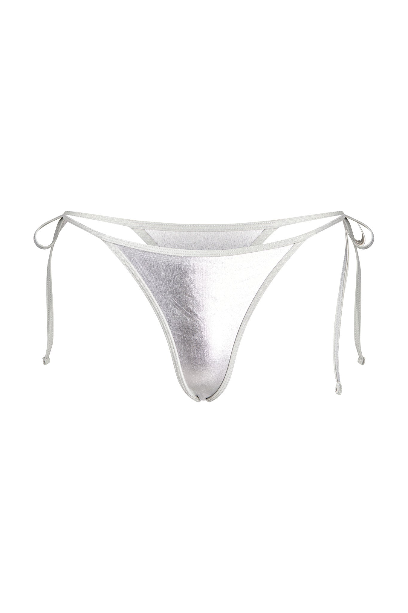 The ALOHI BIKINI BOTTOM in Grey : Silver by I.AM.GIA features a metallic silver design with adjustable side ties. The fabric has a slight sheen that gives it a reflective look. The minimalist design includes thin side straps that can be tied into bows for a custom fit.